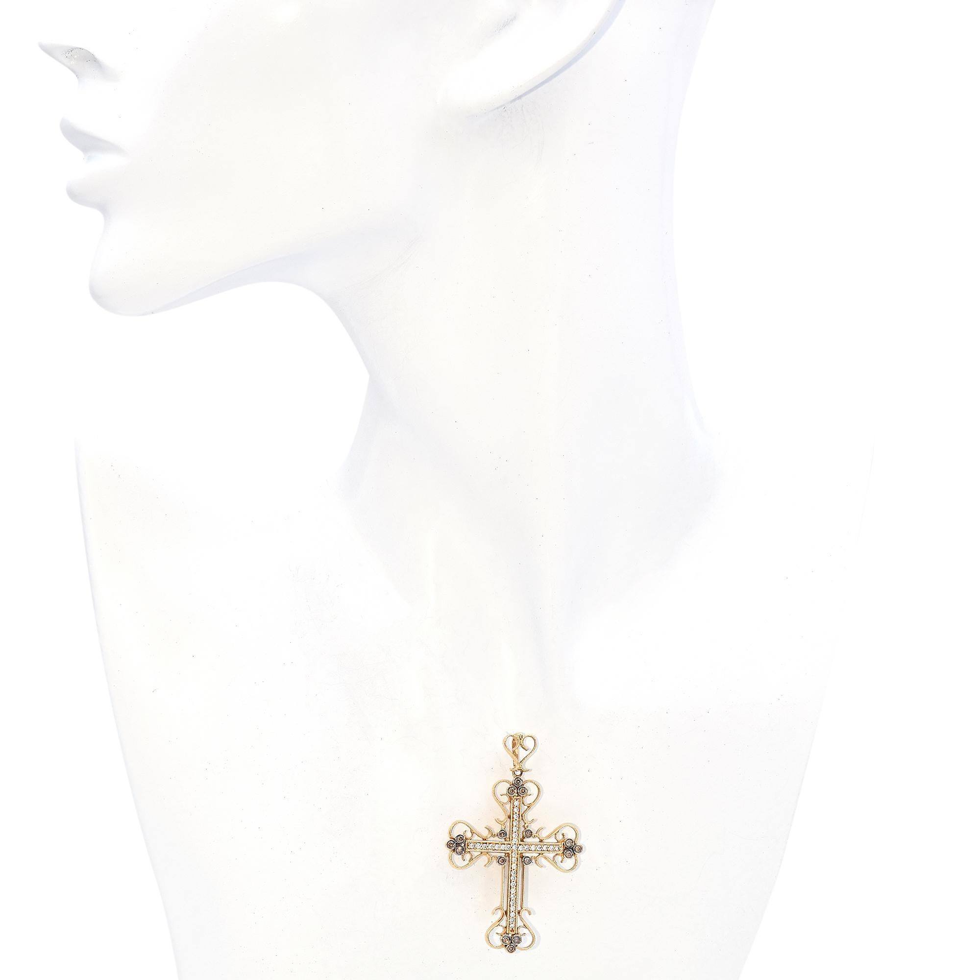 Fabriqué en or jaune 14k, ce pendentif exquis présente un design en croix orné de diamants blancs et champagne.
La croix est minutieusement détaillée avec des filigranes ornés, mettant en valeur un mélange harmonieux d'élégance et d'artisanat.
Les