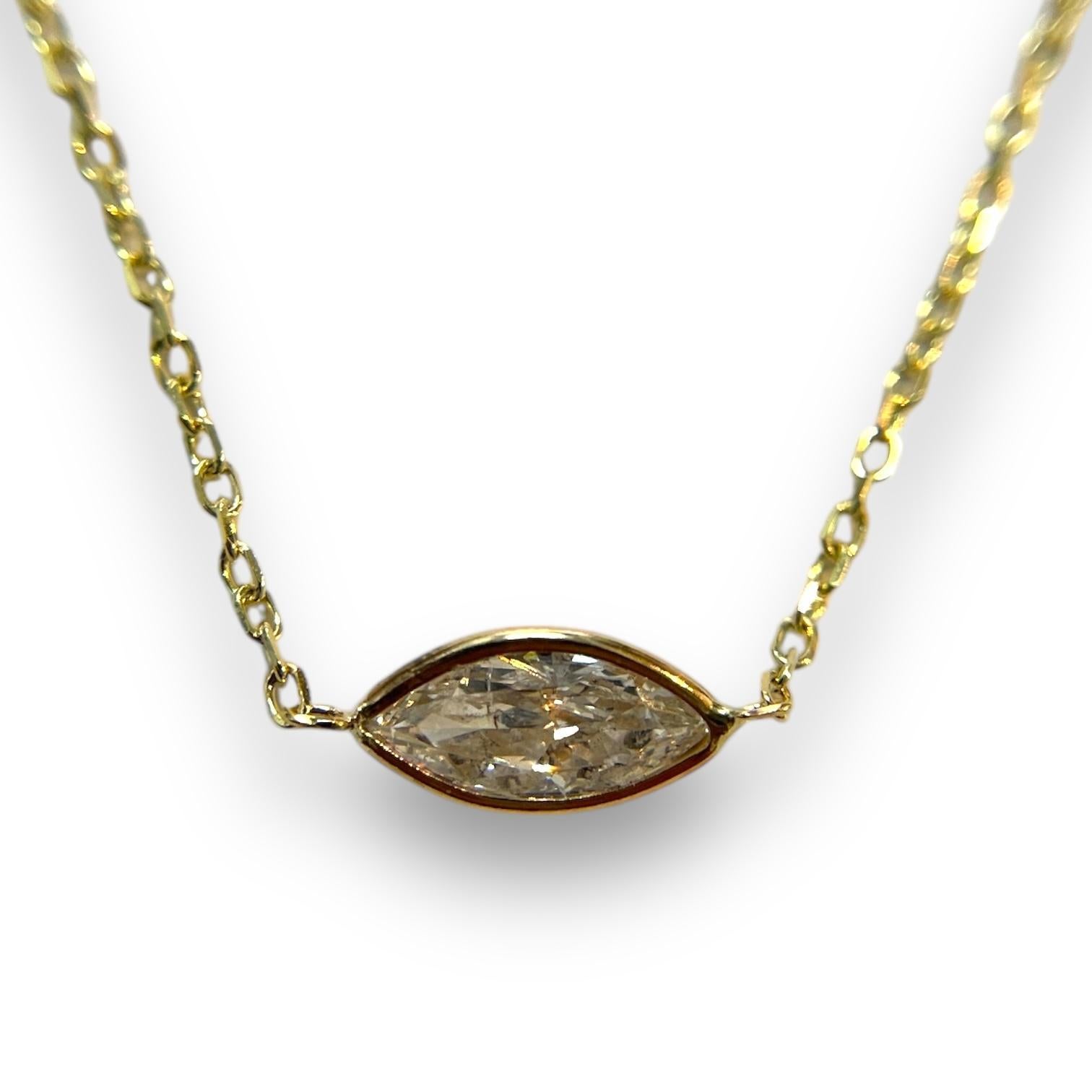 A refined statement piece, this necklace highlights a dazzling 0.70ct natural marquise diamond. Encased in a 14K yellow gold bezel, it combines modern minimalism with a timeless charm.
