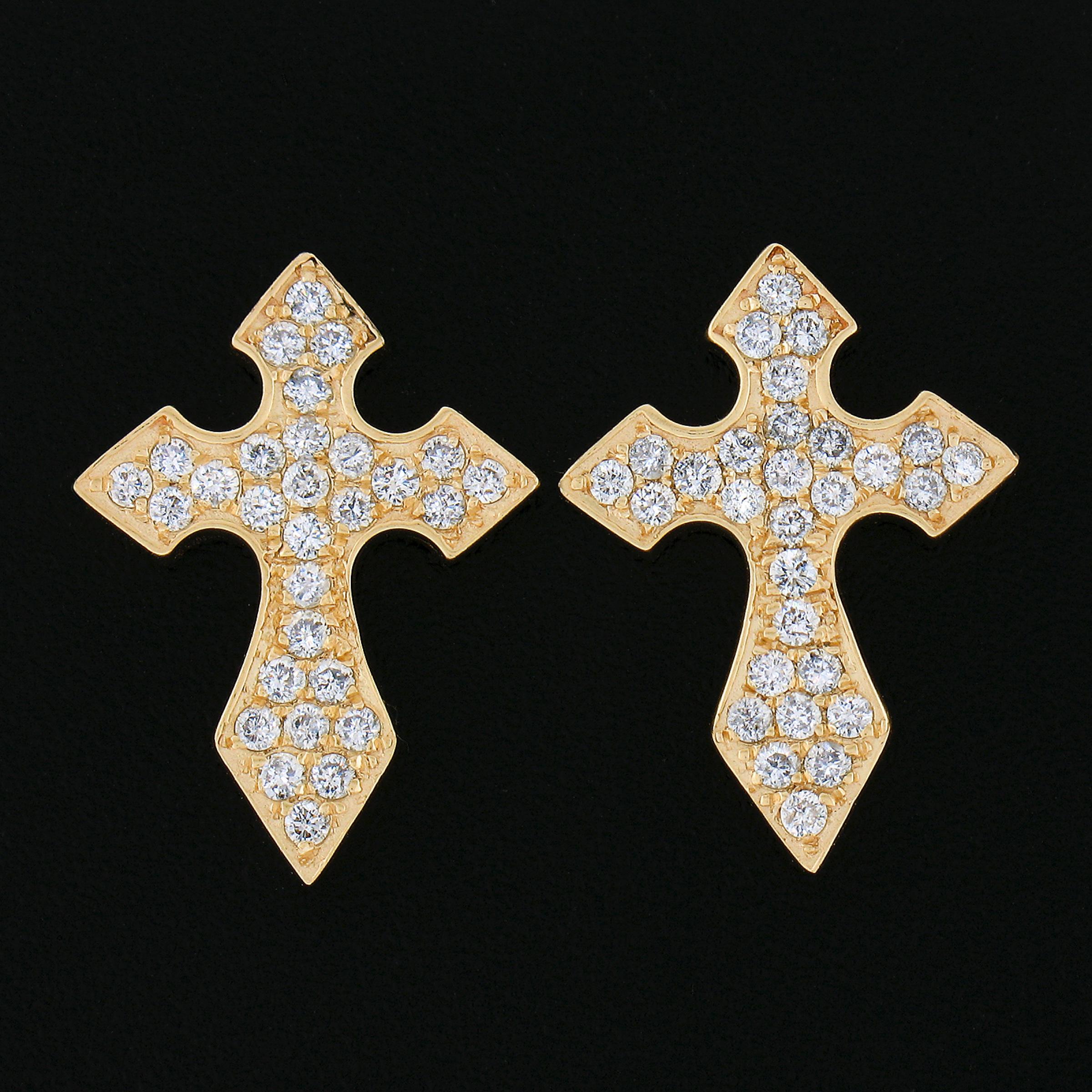 Here we have a beautiful pair of stud earrings that are well crafted from solid 14k yellow gold, featuring an elegant cross design that is drenched with very fine quality diamonds throughout. These fiery diamonds total approximately 0.70 carats in