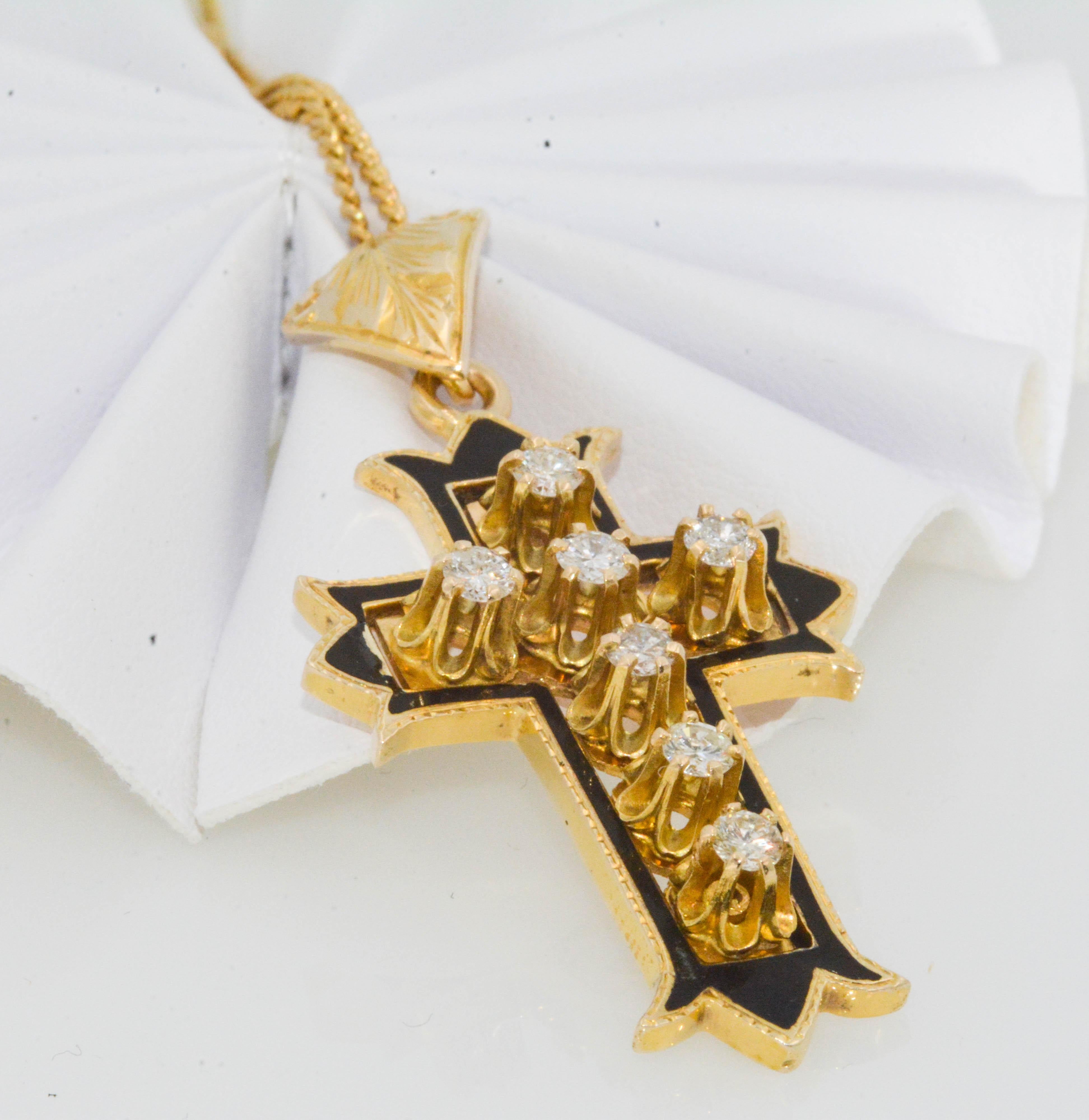 A lovely Circa 1920 Victorian diamond cross pendant. 14 karat yellow gold with black enamel tastefully surrounds 7 round brilliant cut diamonds 0.80 carat total weight (I color, I1 internal clarity). 18 inch 14 karat yellow gold chain. Notice the