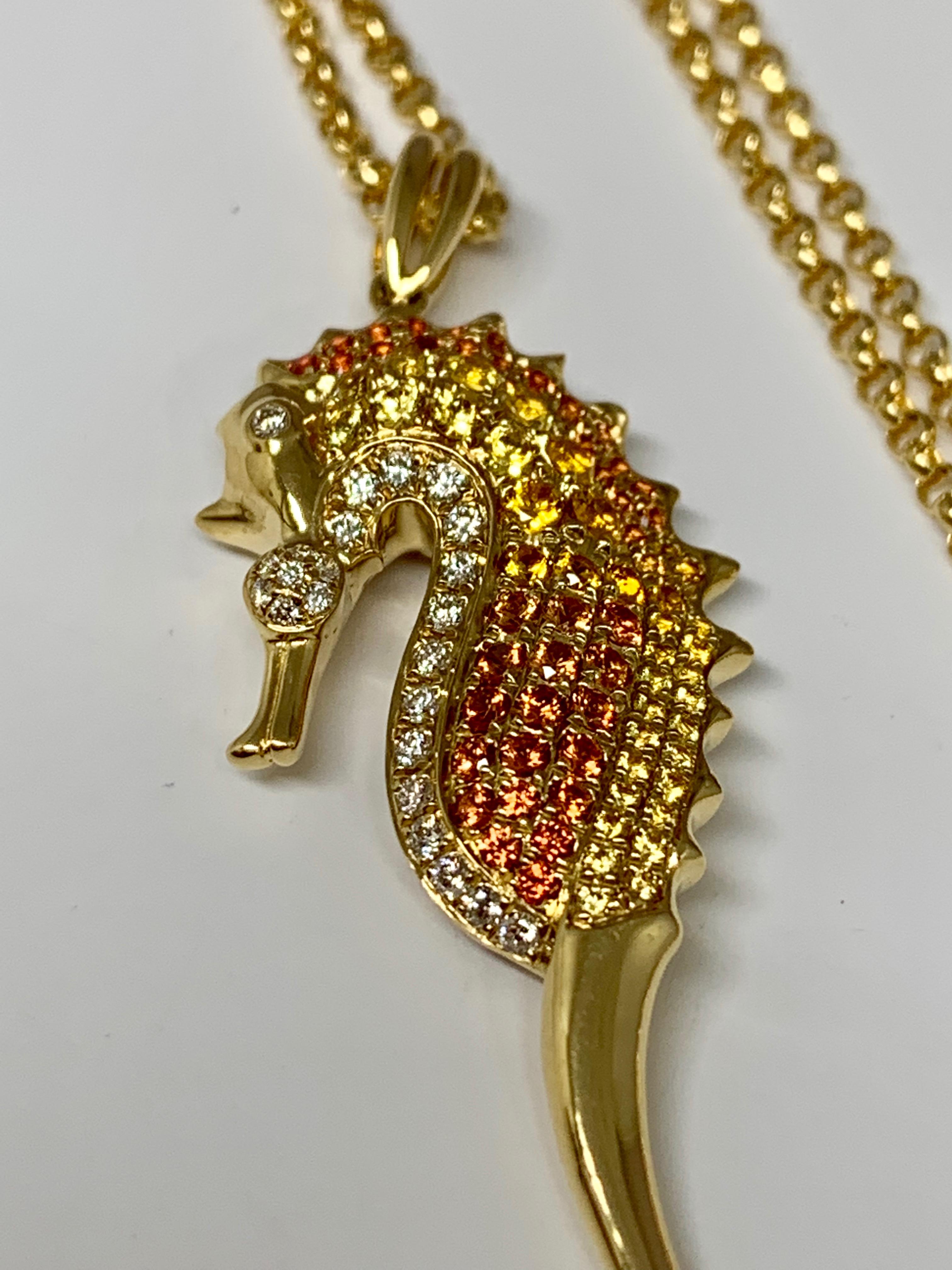 This colorful 14K yellow gold Cherie Dori seahorse necklace features 0.71 carats of round yellow and orange sapphires as well as 0.13 carats of round white diamonds. This necklace includes an 18