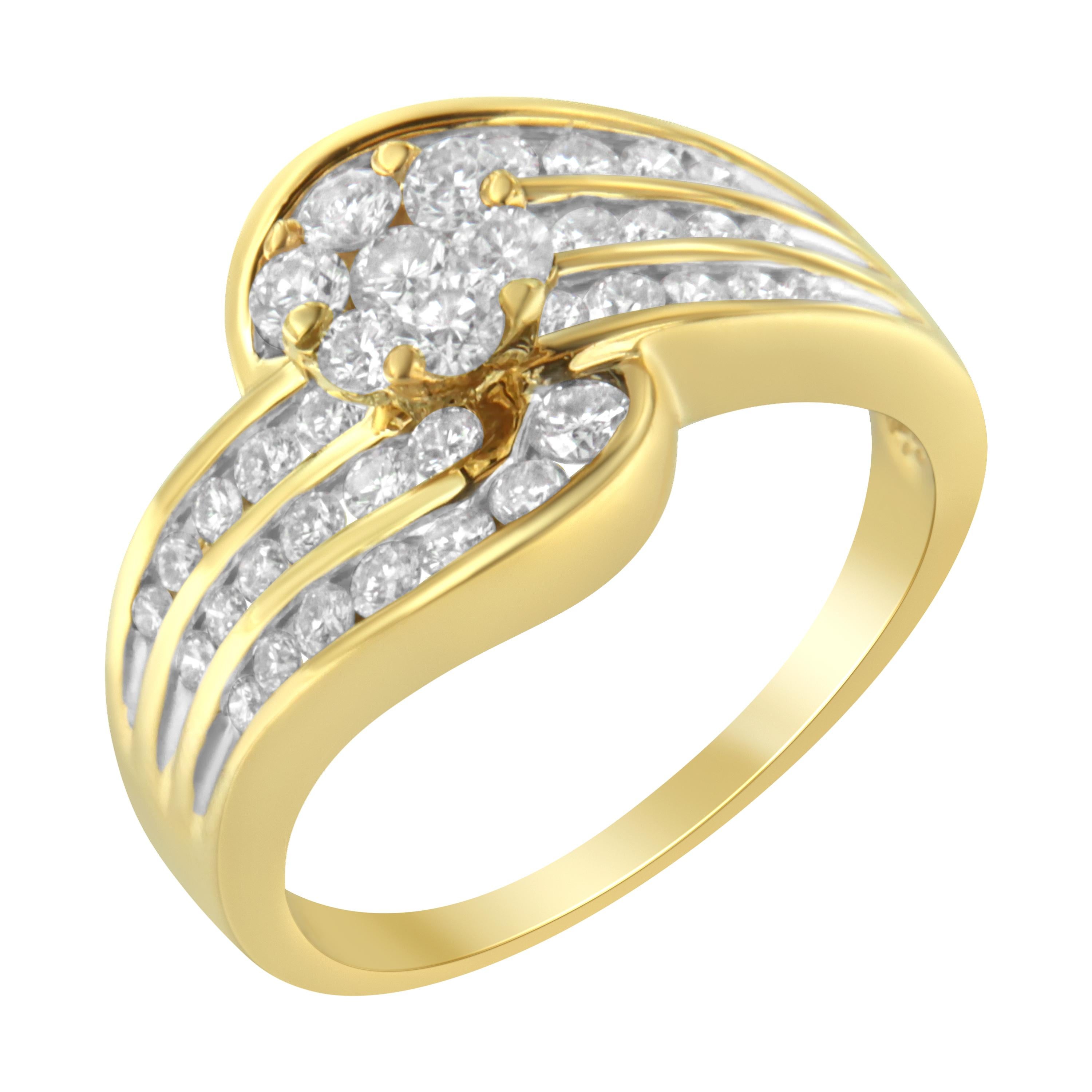 A cocktail bypass ring that features a unique S-form shaped design with a central floral cluster of diamonds surrounded by three rows of channel set round diamonds. The band is crafted in elegant 14 karat yellow gold.

Product Features: 

Diamond