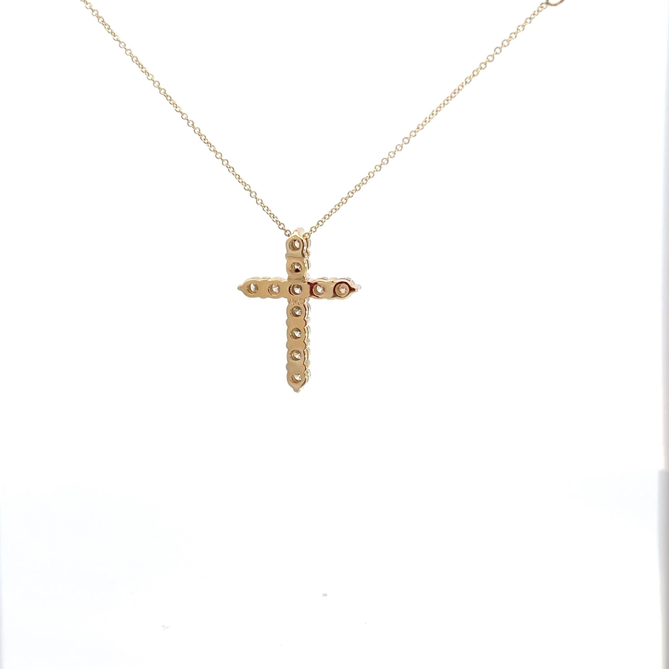 Introducing an exquisite symbol of faith and elegance, behold the mesmerizing 14K Yellow Gold 1.50 carat Diamond Cross Pendant. Crafted with meticulous attention to detail, this stunning piece showcases the timeless allure of a classic cross design.