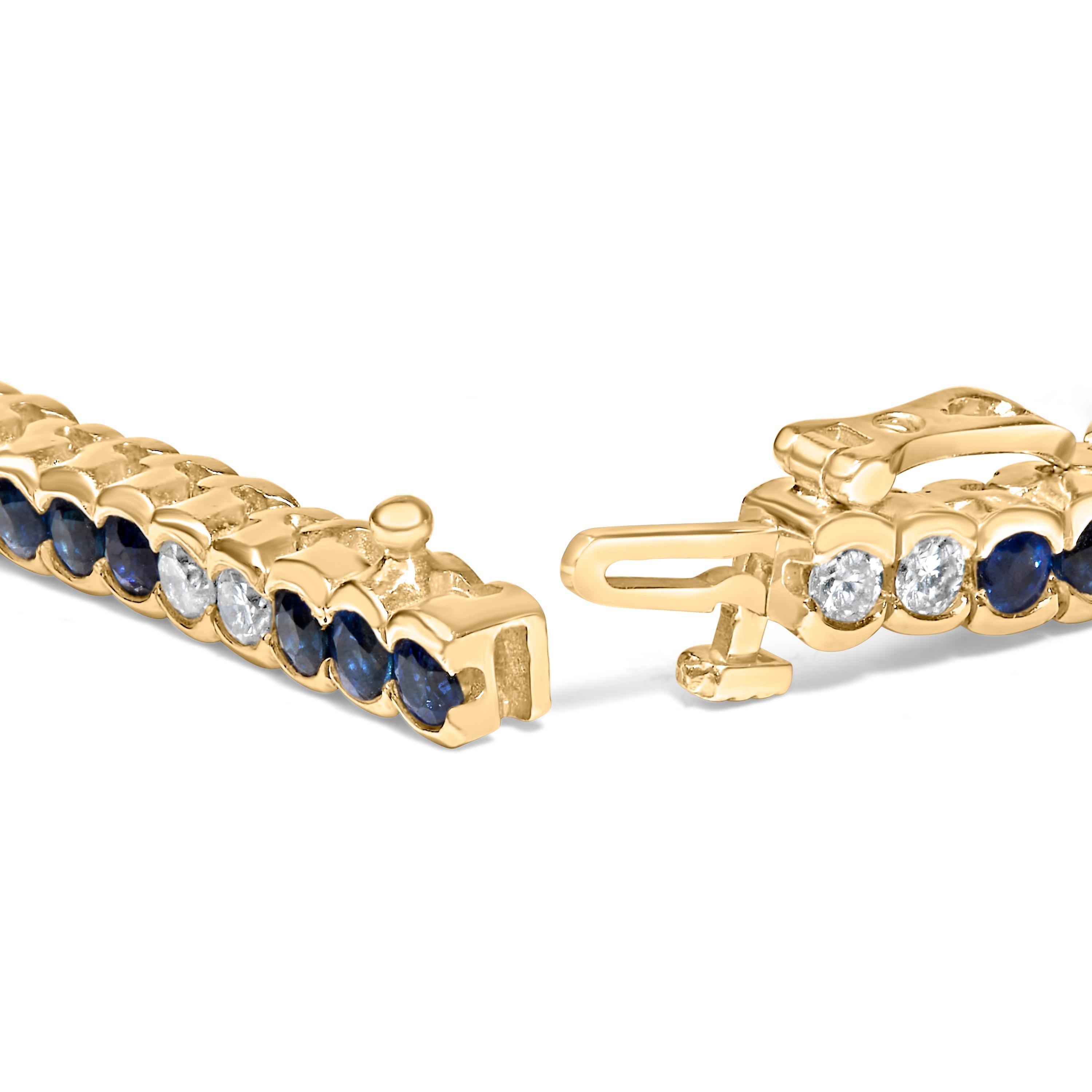 Immerse yourself in the luxury of this exquisite 14K yellow gold tennis bracelet, a harmonious blend of alternating natural, brilliant-cut diamonds and vibrant, color-treated blue sapphires. An enchanting total of 1 3/4 carats of diamonds, boasting