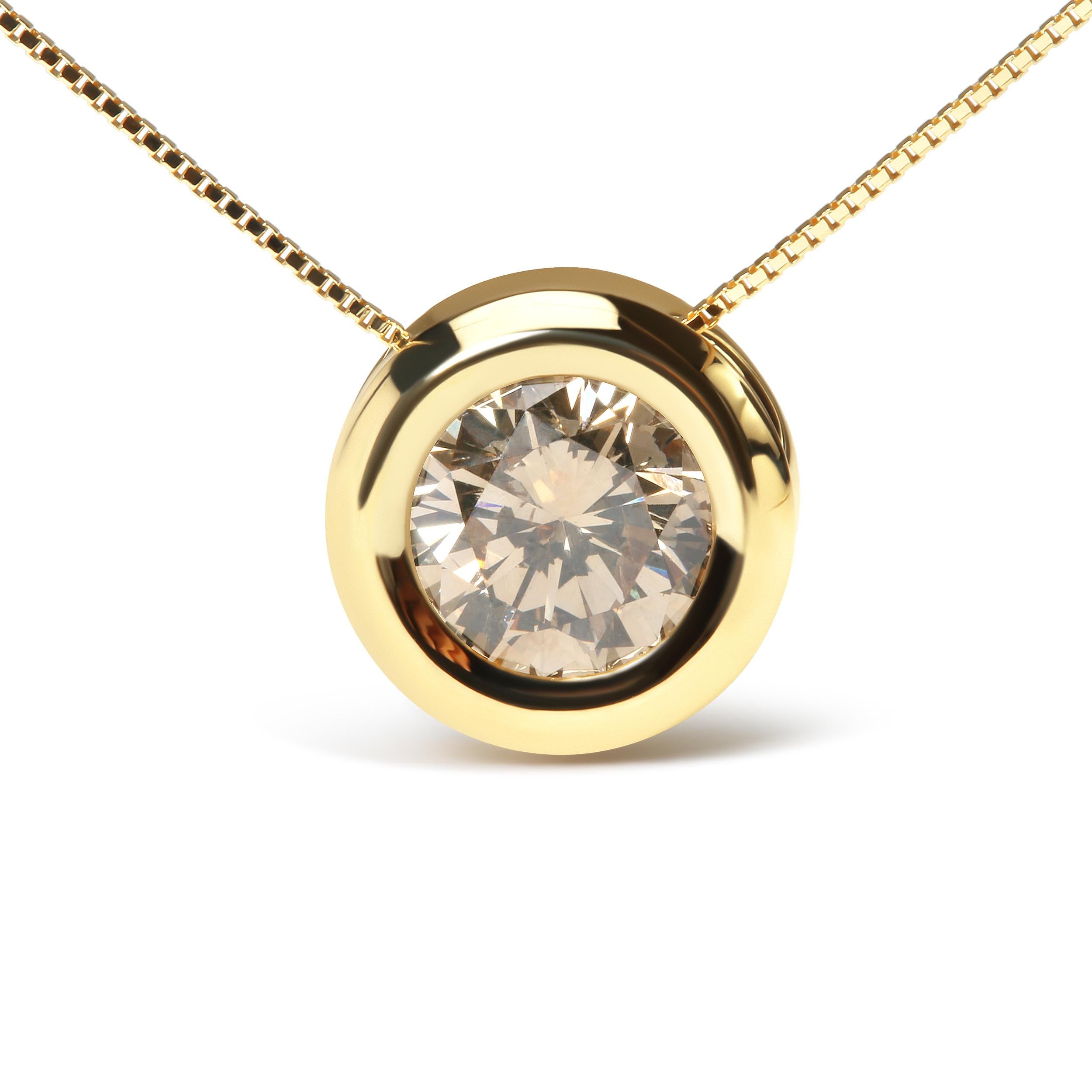 Experience the mesmerizing beauty of this stunning round champagne diamond solitaire pendant necklace. Crafted from 14K yellow gold, this necklace features a luxurious bezel setting that beautifully showcases the 1 3/8 cttw of the solitaire natural