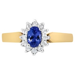 Bague en or jaune 14 carats avec diamant rond de 1/5 carat et halo de tanzanite bleue ovale