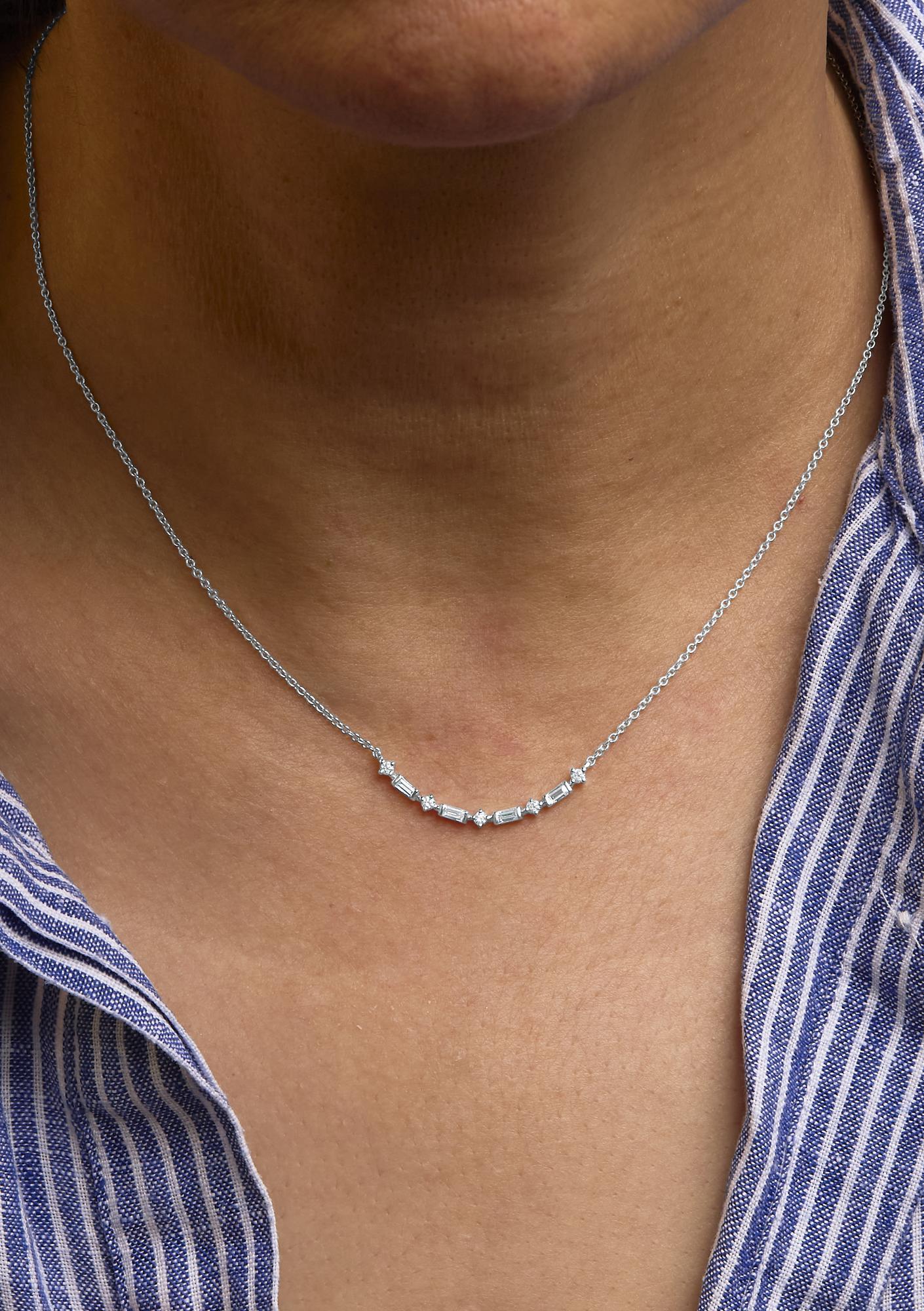 Embrace subtle luxury with our exquisite necklace, sculpted in solid 14K yellow gold. The pendant, a mesmerizing curve bar, is adorned with a quarter carat of natural diamonds that dance in unison, their round and baguette shapes alternating to