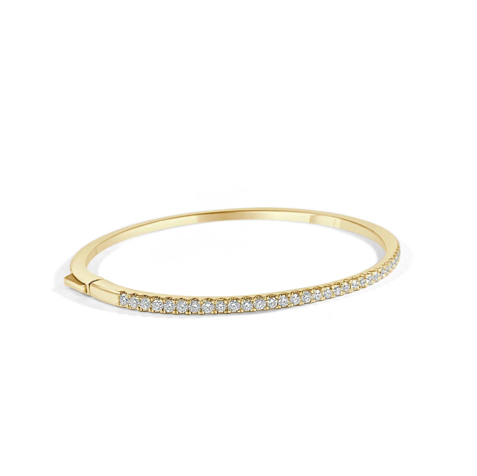 Are you looking to add some sophistication to your ensemble? This elegant diamond bangle for features a row of brilliant round diamonds set in 14k gold. Diamond Color and Clarity is GH SI1-SI2. 
-14K Gold
-1.0 ct. Natural White Diamonds
-Diamond