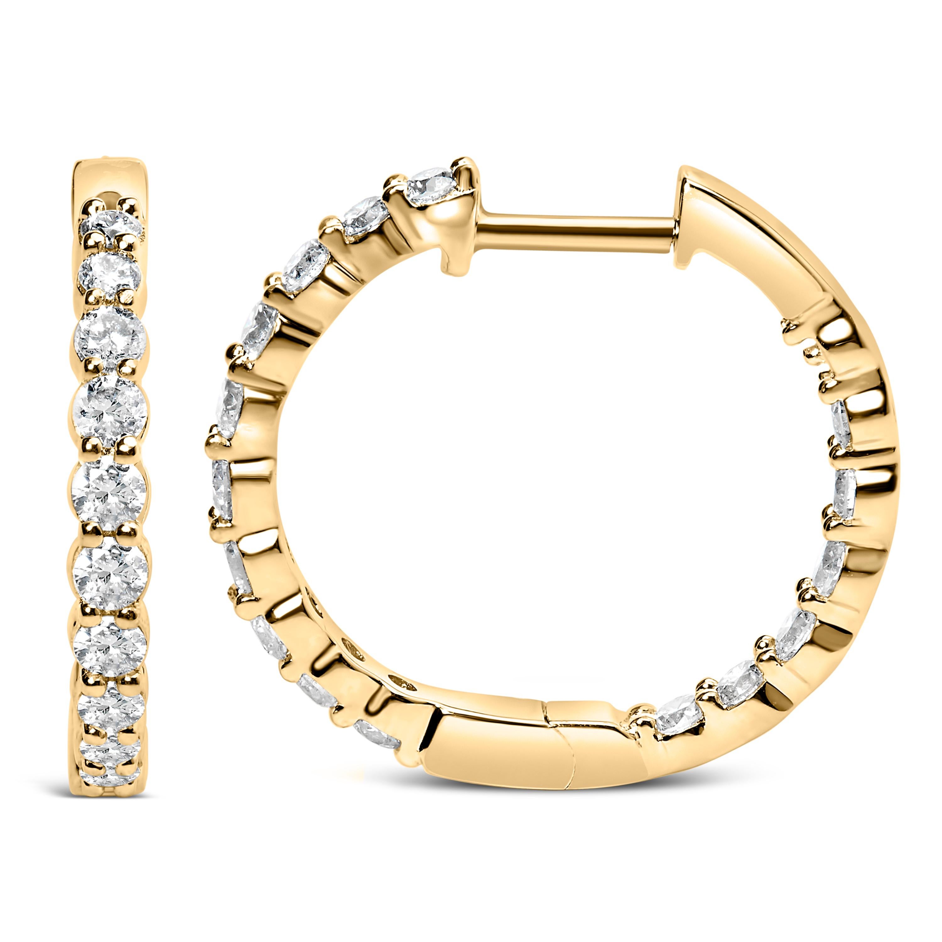 Bask in the glow of timeless elegance with these exquisite hoop earrings, meticulously crafted from 14K yellow gold. Adorned with natural brilliant round-cut diamonds, each earring embodies an enchanting dance of light, thanks to its shared prong