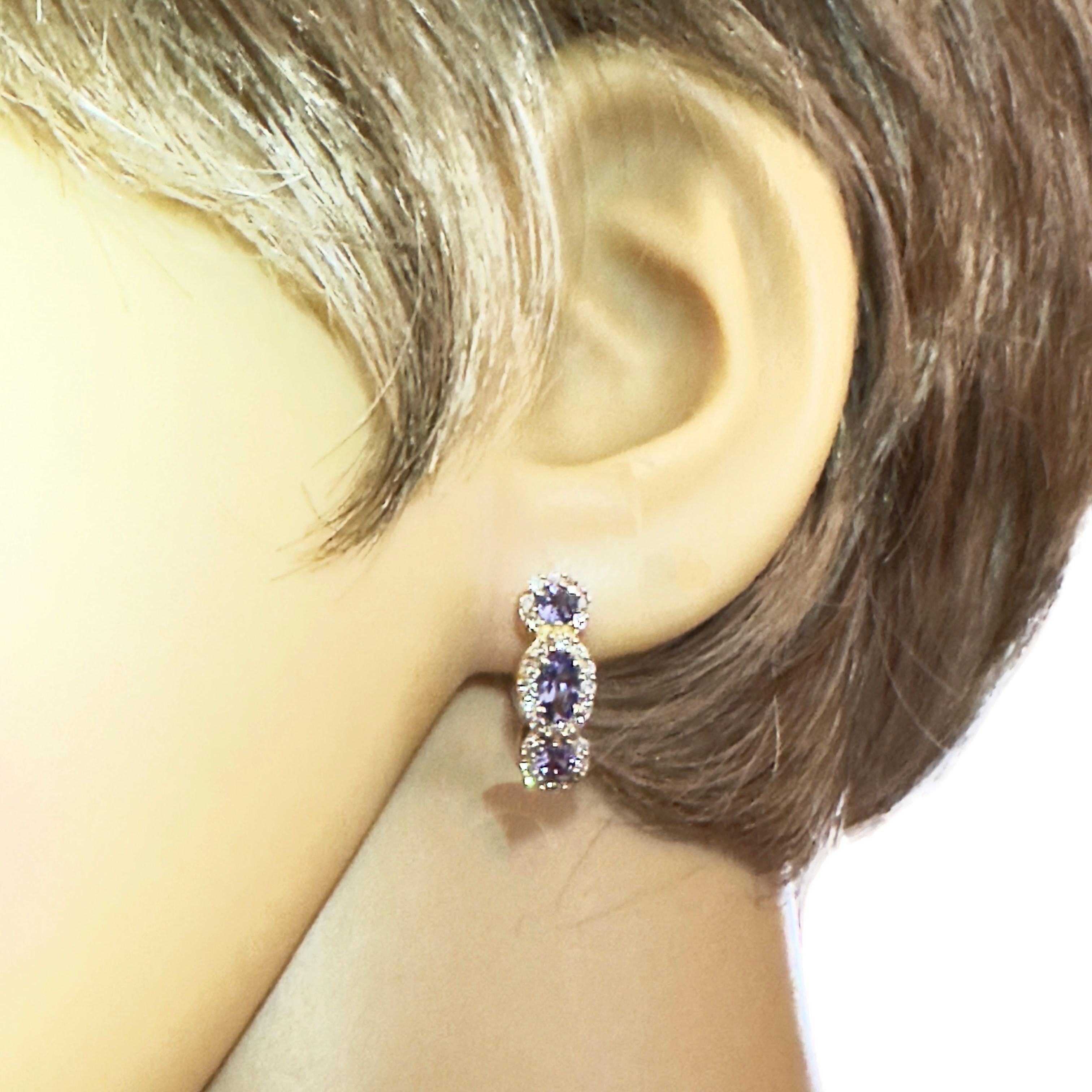 I love these earrings.  The color is just beautiful.  The tanzanites total 1 .05 carats and there are is 1 oval cut and 2 brilliant cut stones in each earring.  Please see the appraisal for measurements.  There are also 25 brilliant cut diamonds in