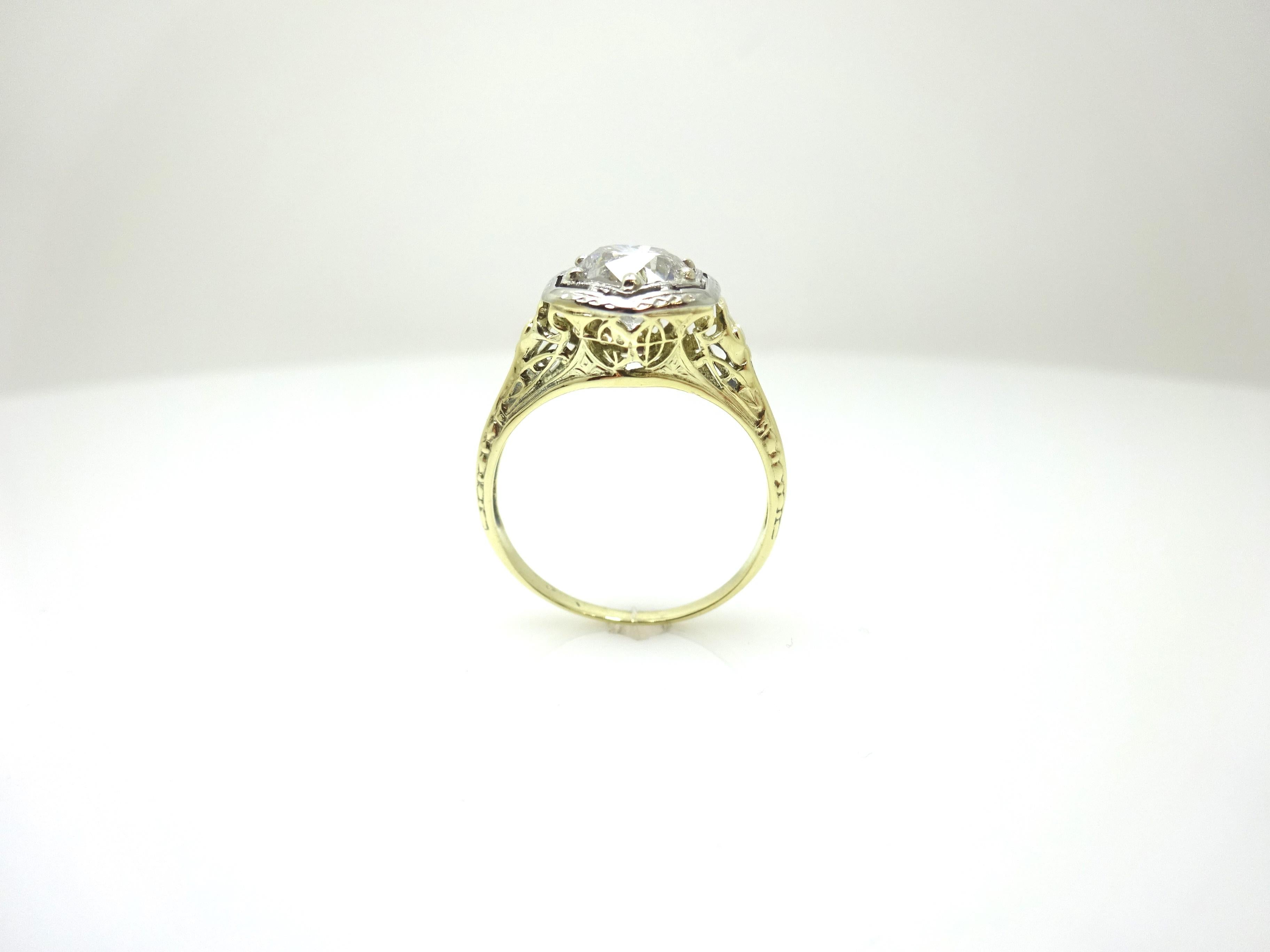 14k Yellow Gold 1.10 Carat Genuine Natural Diamond Filigree Ring (#J3673)

Art Deco 14k yellow gold diamond filigree ring featuring a large round brilliant cut diamond weighing 1.10 carats. The diamond is set in a white gold head with rare yellow