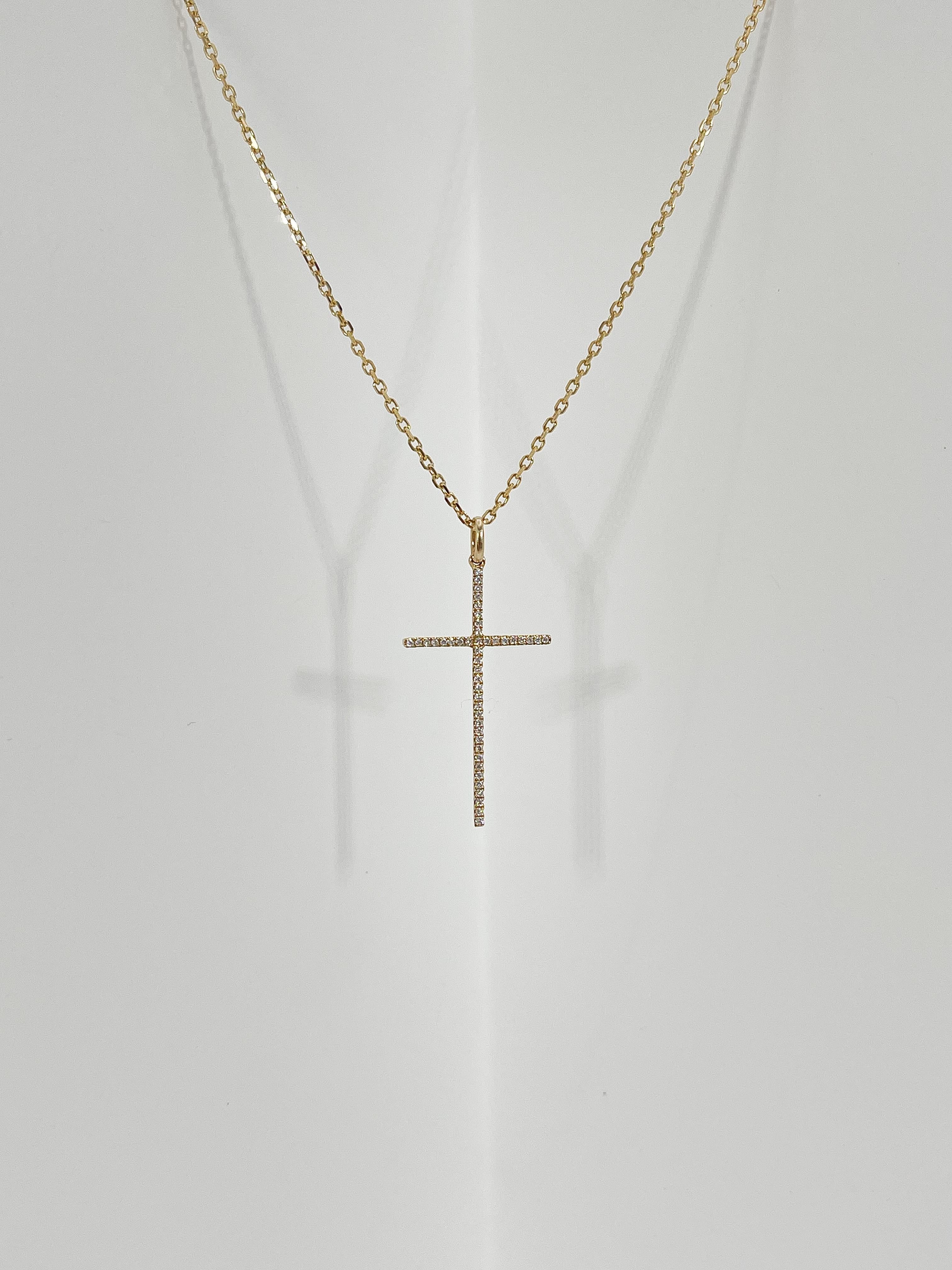 14k yellow gold .12 CTW diamond cross necklace. The stones in this necklace are all round, has a lobster clasp to open and close, the length of the necklace is 17 inches, the cross measures 29.5 x 16.5 mm, and has a total weight of 2.5 grams.