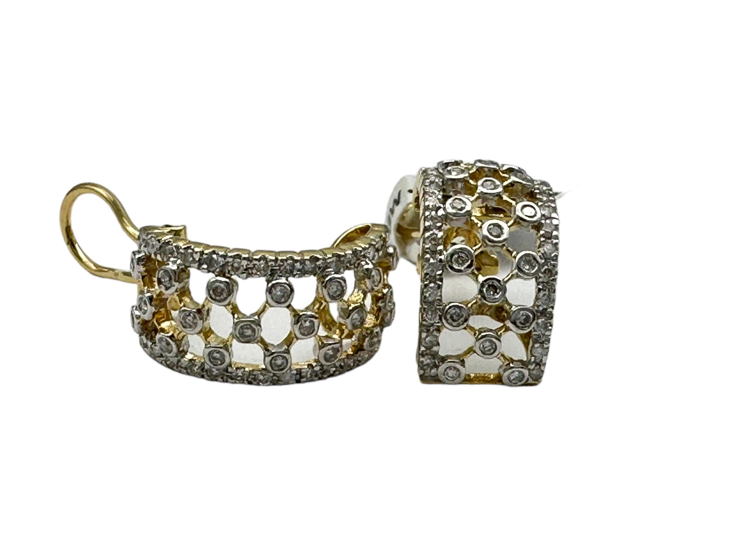 14 Karat white gold diamond earrings with yellow gold trim. The earrings are an open-lacey style with diamonds pave and bezel set. The measurements are .84 inches long x .22 mm wide.
Approximately 80 diamonds average 1.10-1.80 mm having a total