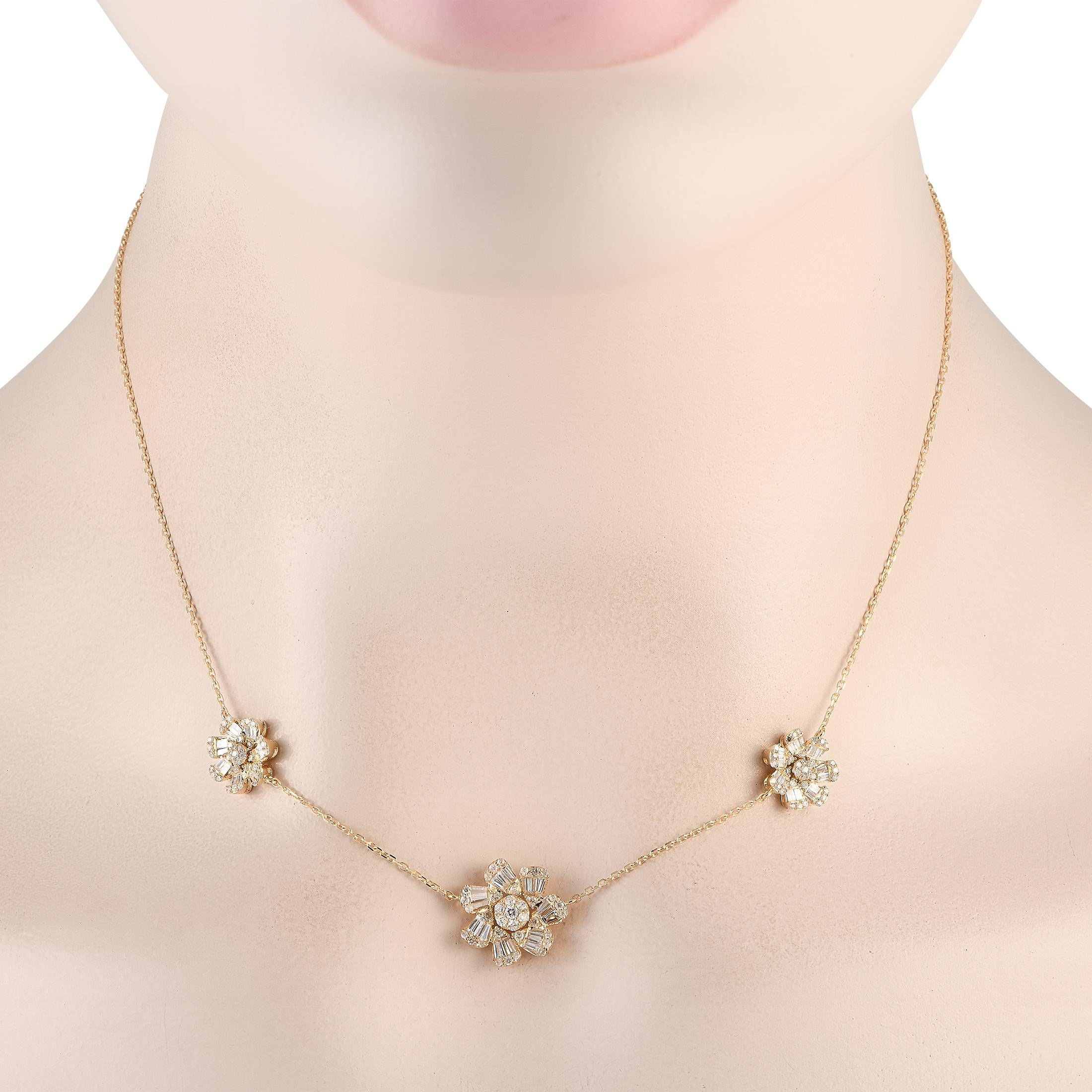 This 14K Yellow Gold necklace is incredibly sophisticated. The delicate 16 chain is elevated by a trio of floral motifs  the central motif measuring 0.50 round. Diamonds with a total weight of 1.20 carats make it a luxury piece that is ideal for any