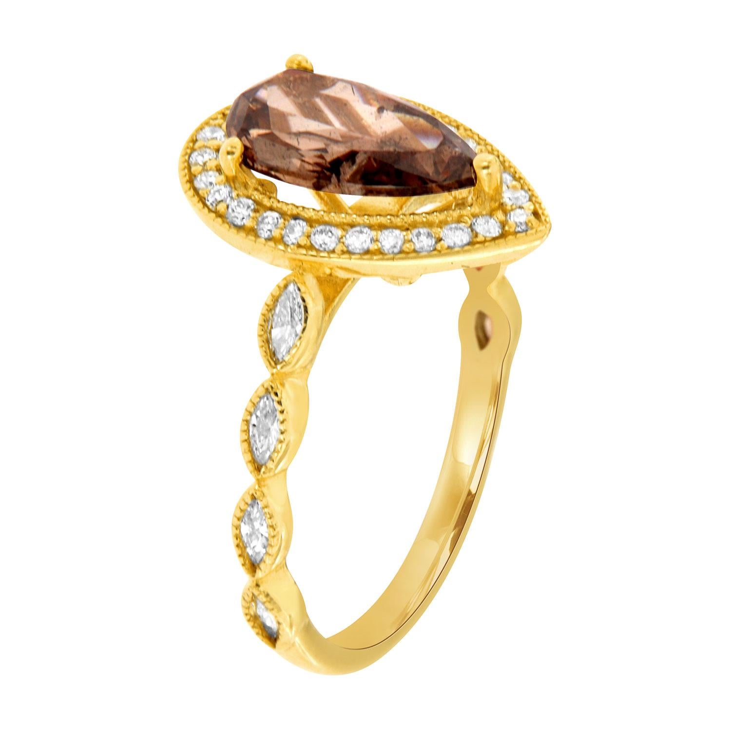 This 14k yellow gold ring features a 1.25- Carat Pear shape brilliant Champagne color Natural Diamond encircled by a Milgrain designed halo of brilliant round diamonds on top of a 2.2 MM wide Marquises shape diamond band.
This unique diamond