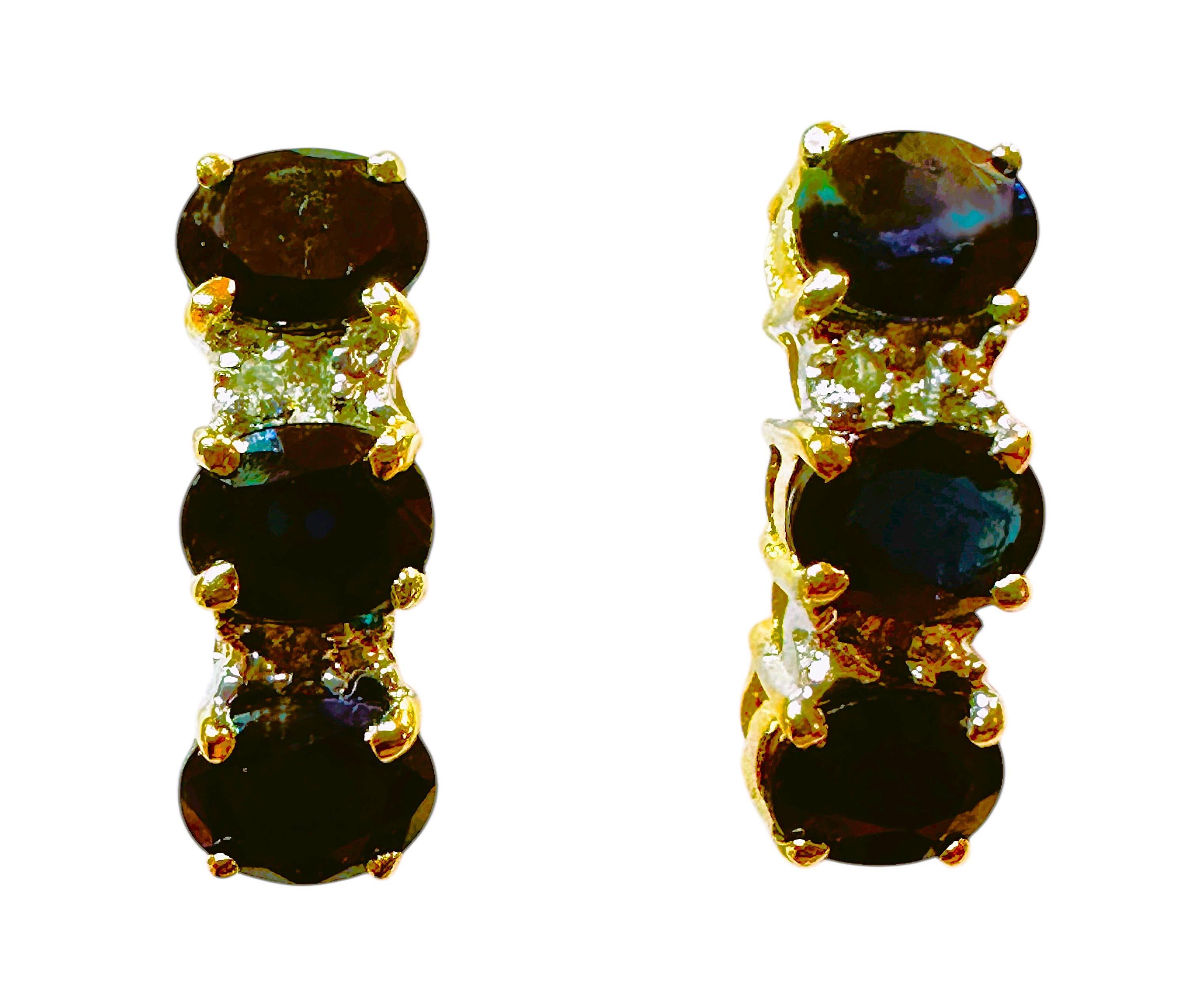 These earrings are just beautiful!  They are 14k yellow gold and have three 3.75 mm natural sapphire on each earring which totals 1.25 carats for both earrings. The earrings have small brilliant cut diamonds in between the sapphires.  The earrings