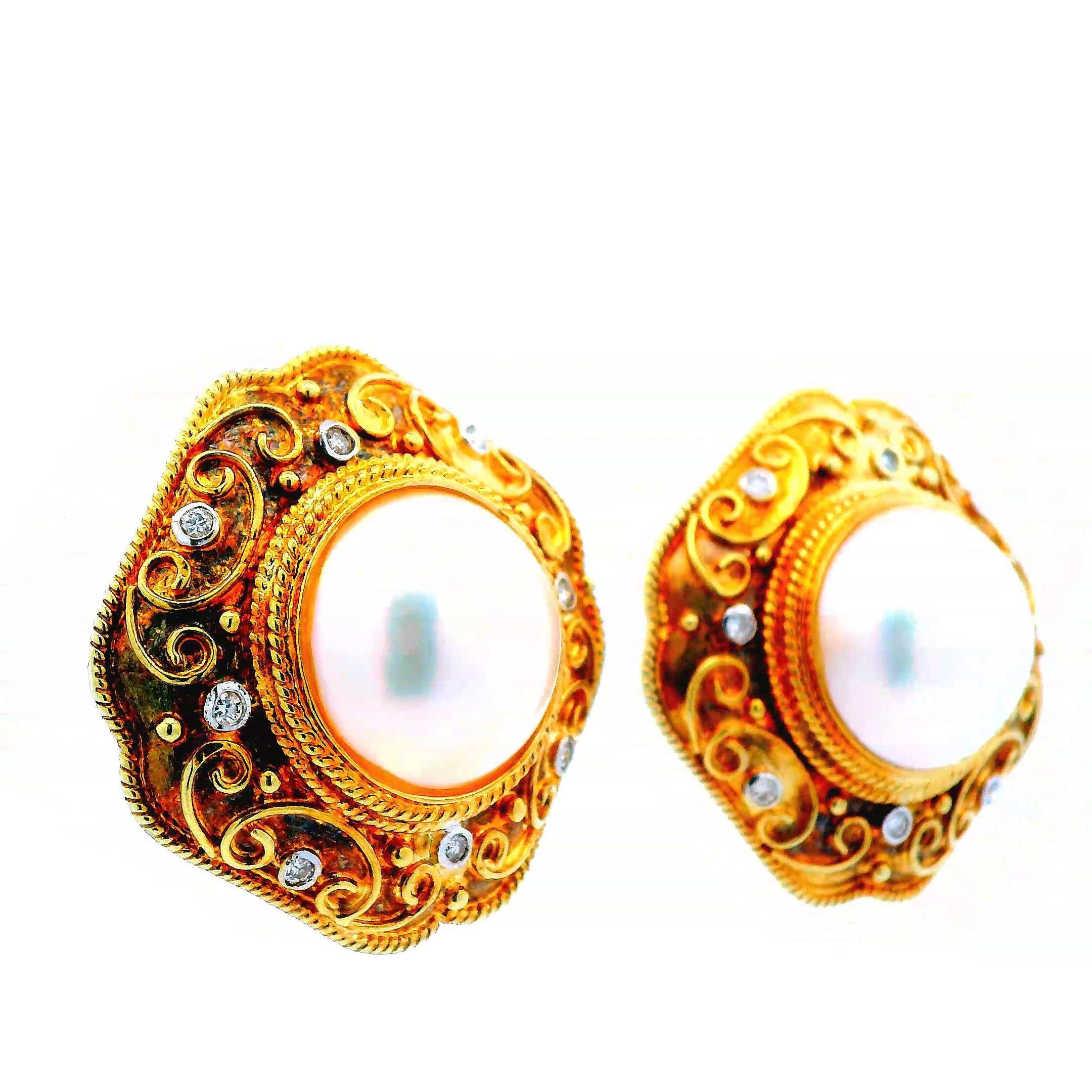 This elegant pair of earrings are made in 14k yellow gold with diamonds and mabe pearls. Mabe pearls are half-pearls grown on the inside of the shell of oysters, creating a unique dome shape. The center of these earrings contain 14.5mm mabe pearls