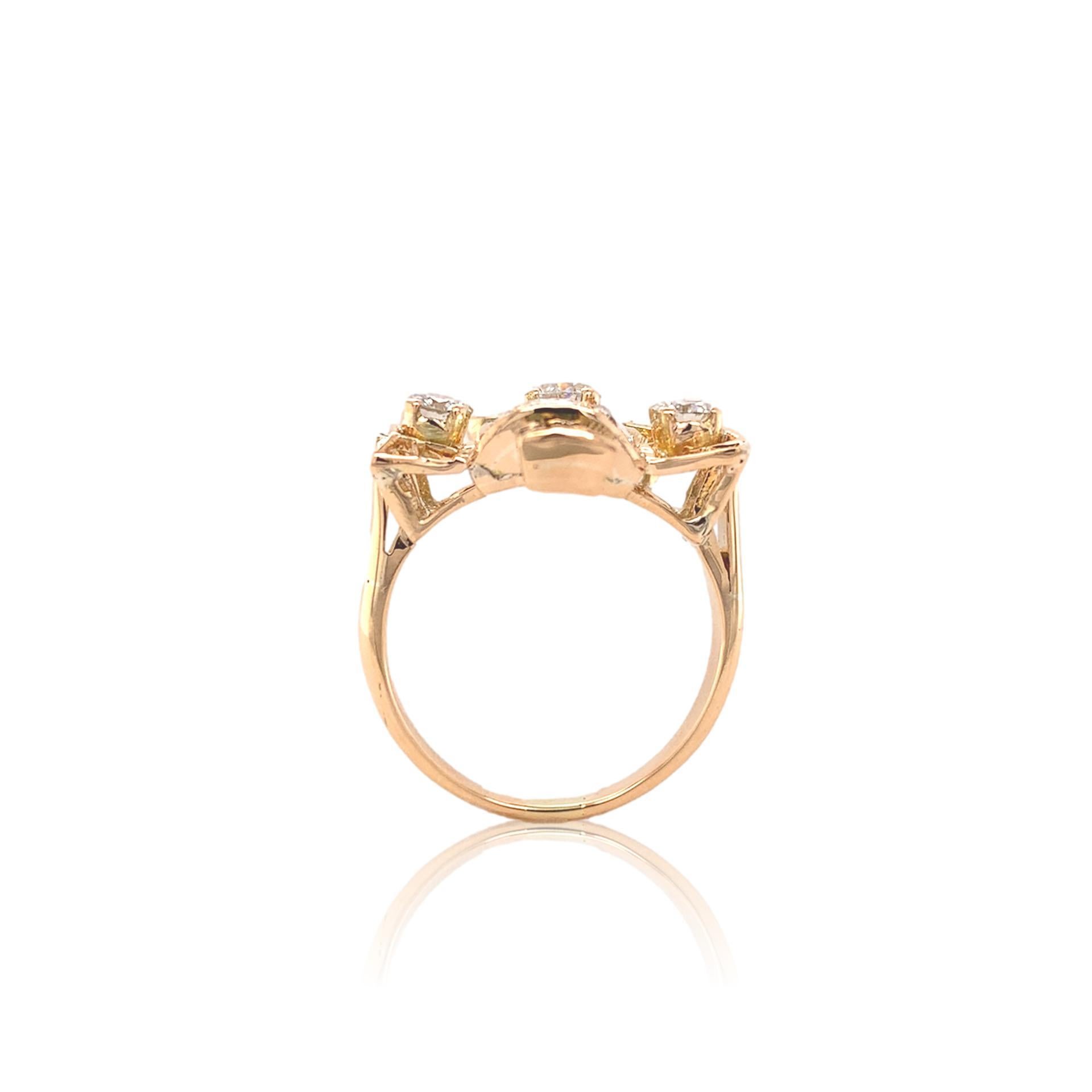 Retro 14k yellow gold ring featuring a diamond bouquet of tulip flowers with emerald stems.  There are 9 round diamonds of which 3 are round brilliant cuts and 6 are transitional to European cut. The largest diamond measures about 3.7mm  The