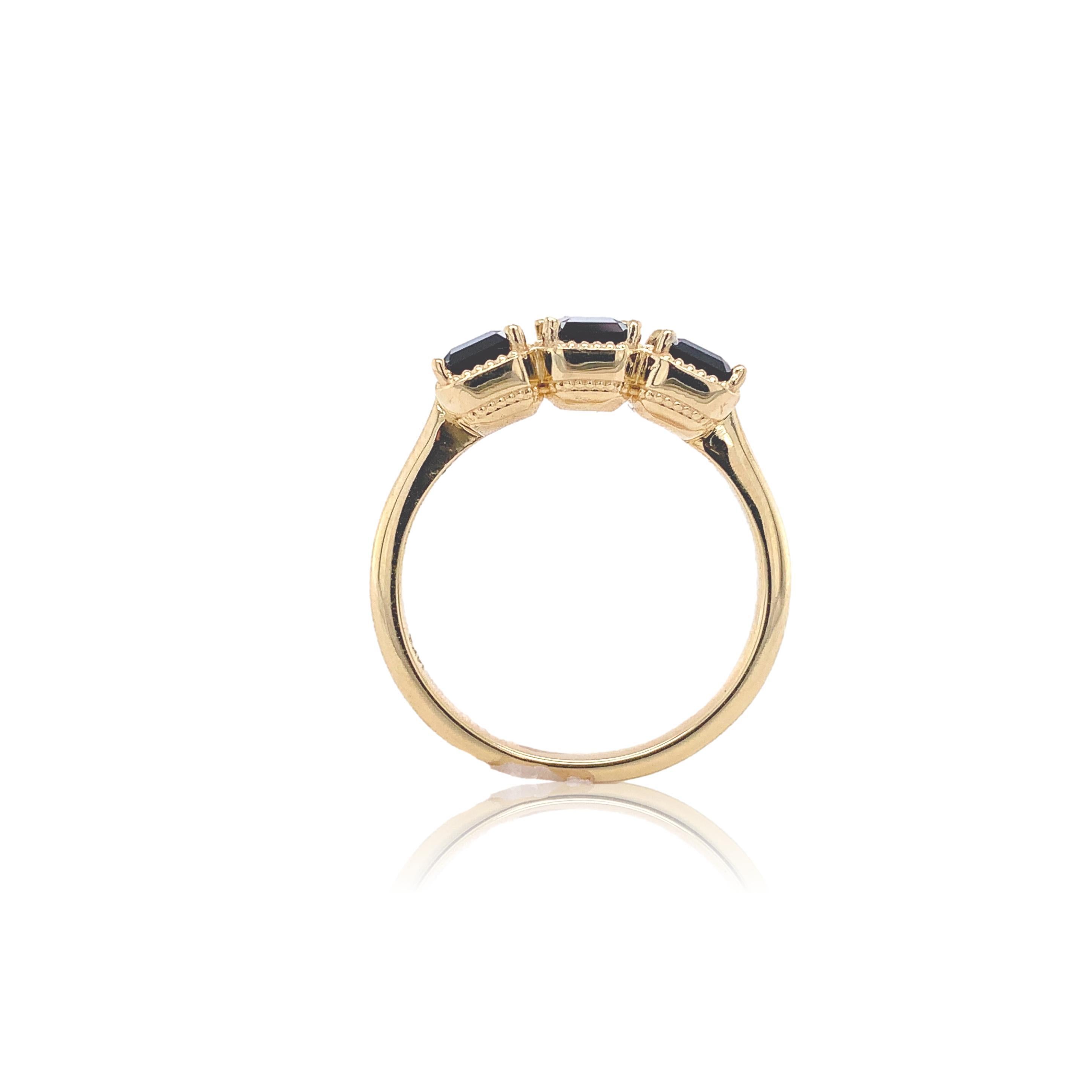New 14K yellow gold 3 stone ring with green tourmalines. The 3 emerald cut tourmalines weigh 1.53cts total. The tourmalines have forest green color and measure about 6mm x 4mm. The ring fits a size 6 3/4 finger and weighs 2.66dwt. Unused.