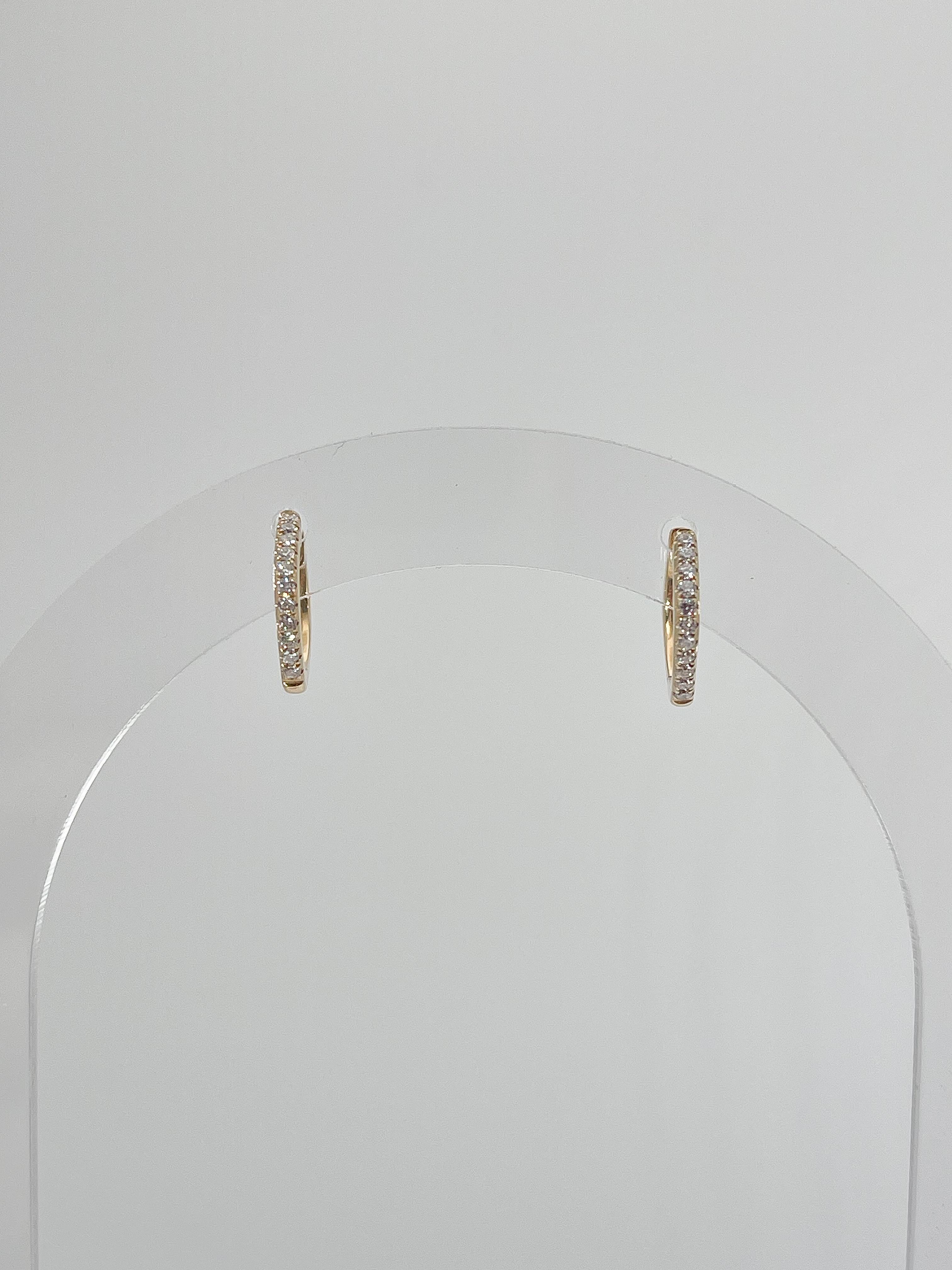 14k yellow gold .17 CTW diamond squared hoop earrings. The hoops are hinged for easy opening and wearing. The hoops measure 11.5 x 11.5 and they have a total weight of 1.6 grams. 