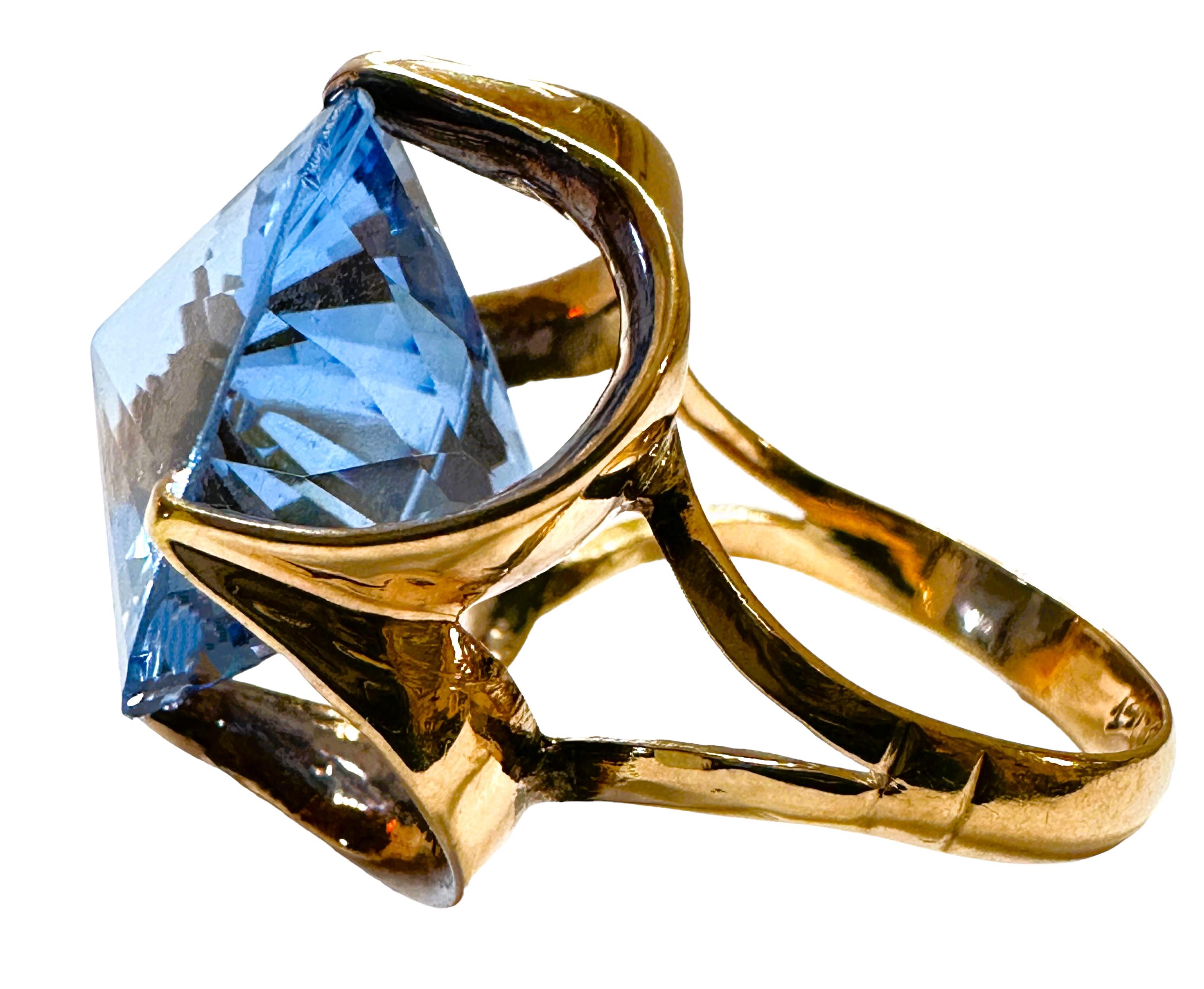 This is phenomenal ring!  The color and cut of the stone is just brilliant.  It is a pre-owned 5.6 DWT Cornflower Blue Topaz.  It is a size 6.5.  The stone  measures 17 mm.  The clarity is Excellent.  It is set in a beautiful decorative 14k Yellow