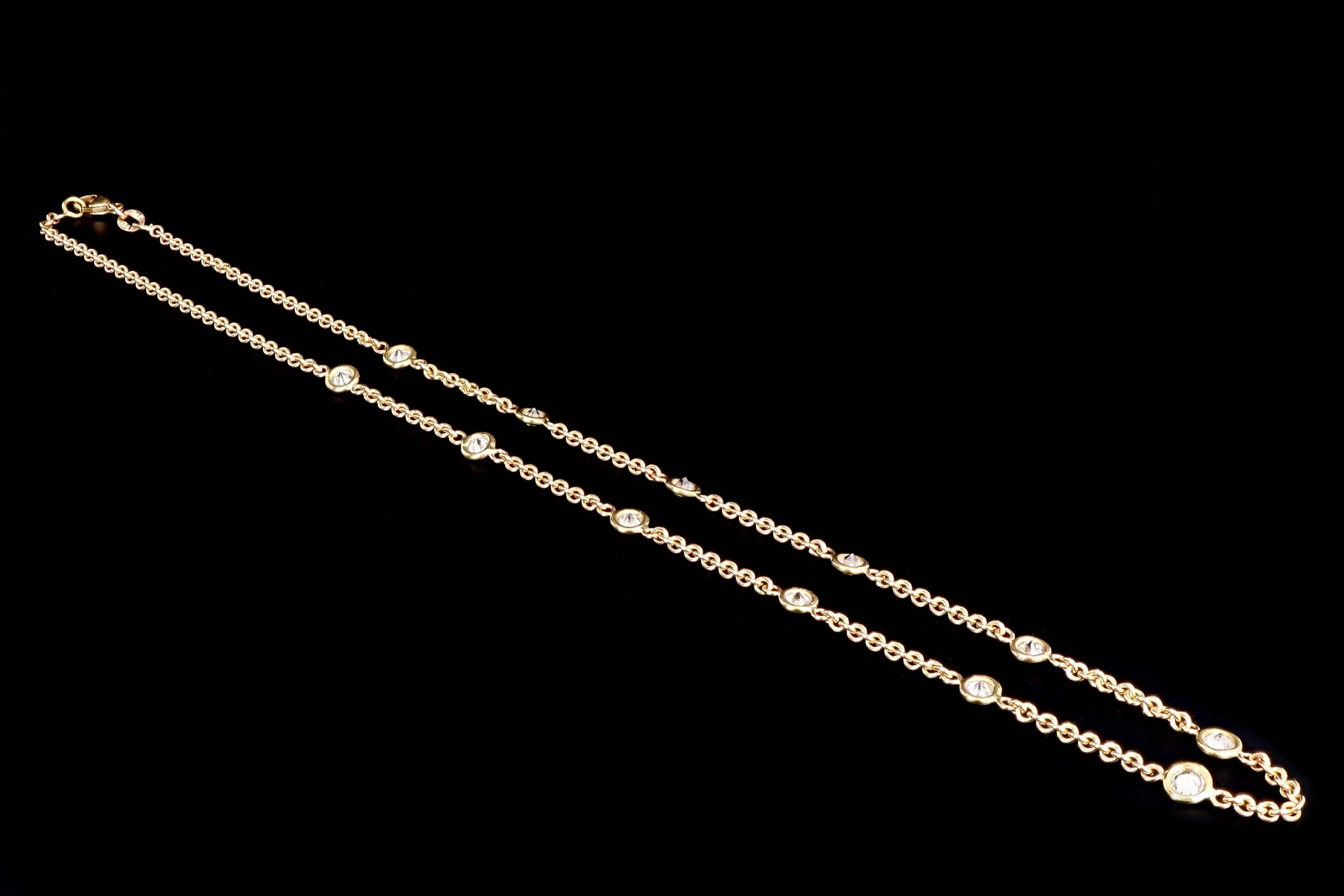 Era: Modern

Composition: 14K Yellow Gold

Primary Stone: 12 Round Brilliant Diamonds

Total Carat Weight: Approximately 1.8 Carats

Color/Clarity: G-H / SI1-2

Necklace Length: 17 Inches

Necklace Weight: 8.2 Grams