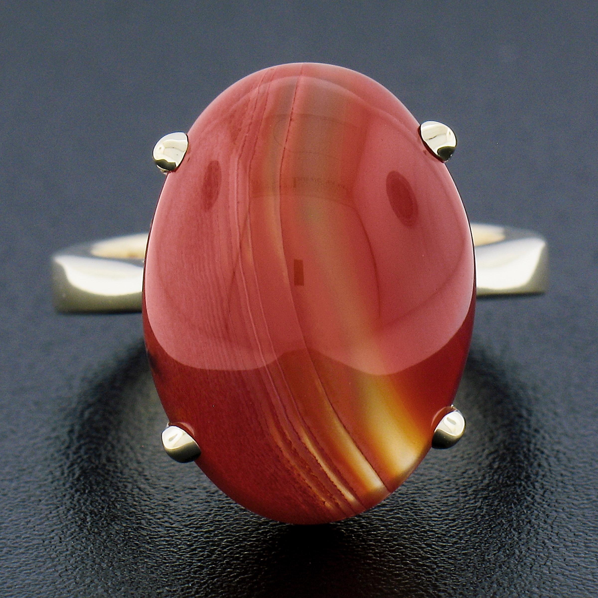 --Stone(s):--
(1) Natural Genuine Agate - Oval Cabochon Cut - Prong Set - Orange Color with Striations Lines - 18x13mm (approx.)

Material: Solid 14K Yellow Gold
Weight: 7.62 Grams
Ring Size: 6.5 (Fitted on a finger. We can custom size this ring -