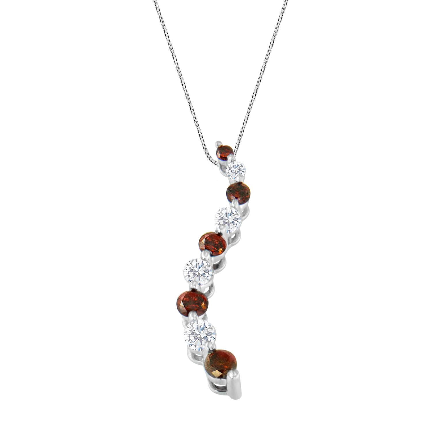 A cascading S curve of 14k white gold showcases round-cut red and white diamonds in this coveted pendant. Each stone is carefully prong set to catch the light for maximum sparkle. Ships with size 18 chain secured with a spring ring clasp. This