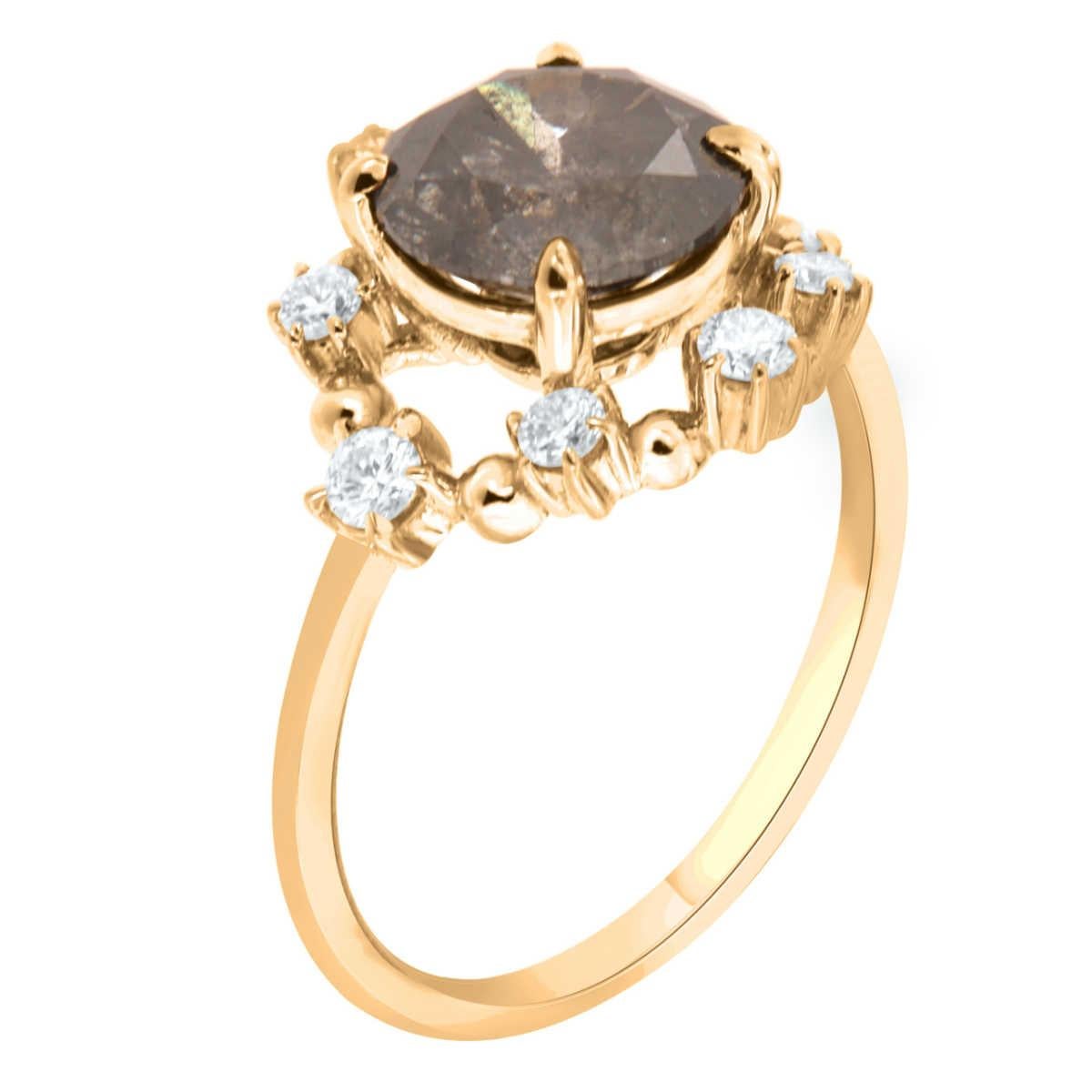 This 14k yellow gold delicate rustic ring features a 2.16 Carat Round shape Salt & Pepper Natural Diamond encircled by a halo of eight (8) brilliant round diamonds on top of a 1.4 MM wide band. 
The total diamond weight on the ring is 0.29-Carat.