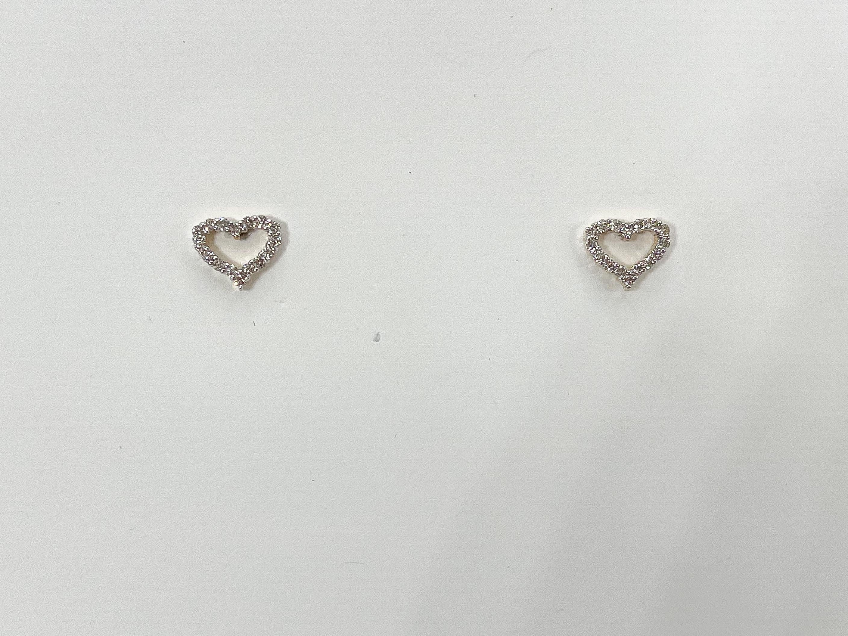14k yellow gold .23 CTW diamond heart studs. The diamonds in these earrings are round cut, they measure 6.5x 8 mm, and they have a total weight of 1.24 grams. 