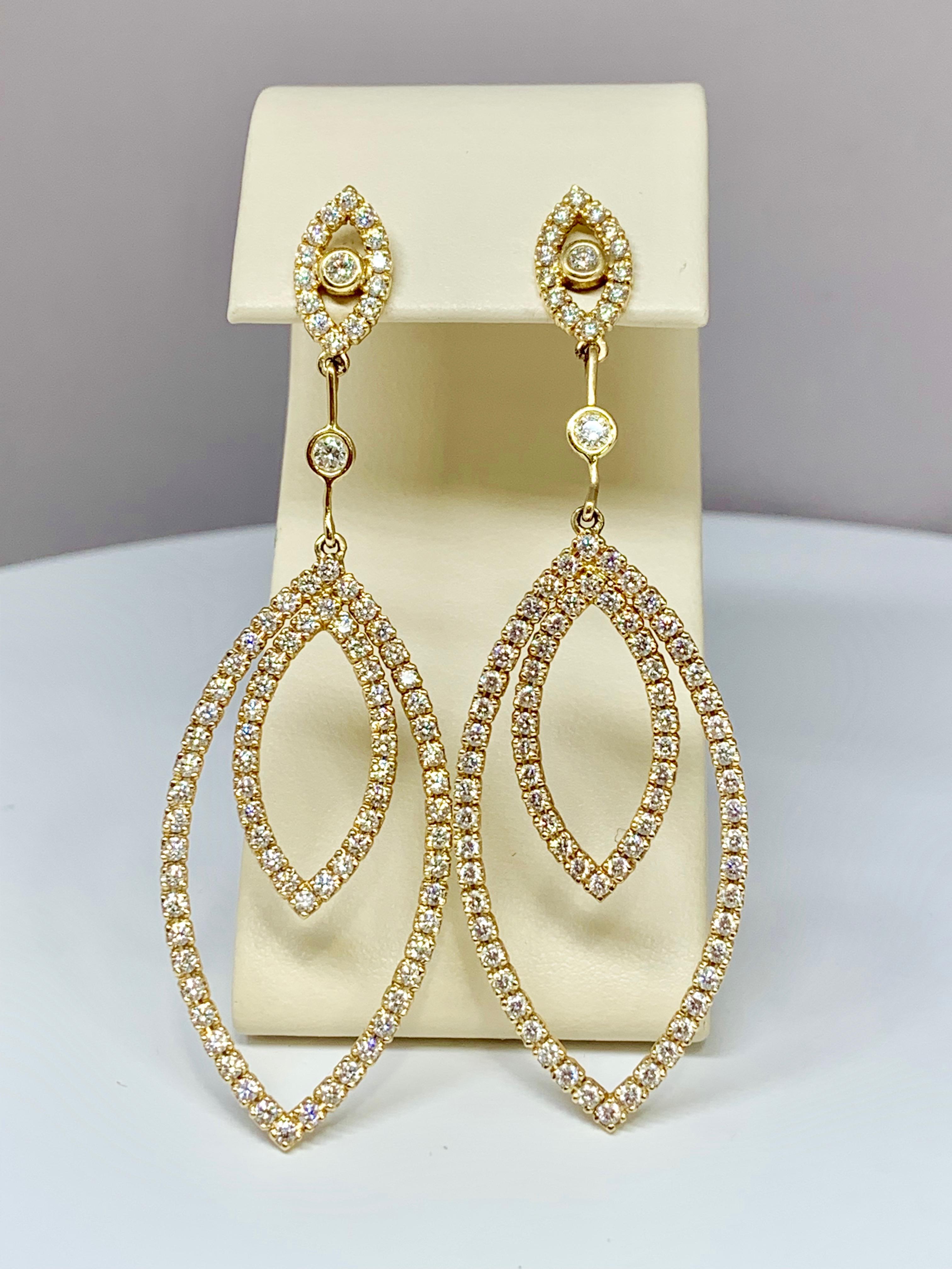 These gorgeous 14K yellow gold diamond earrings are custom-made and hold 2.35 carats of round white diamonds. These earrings include locking backs for ultimate protection during wear time. The perfect accessory for weddings, events, or special