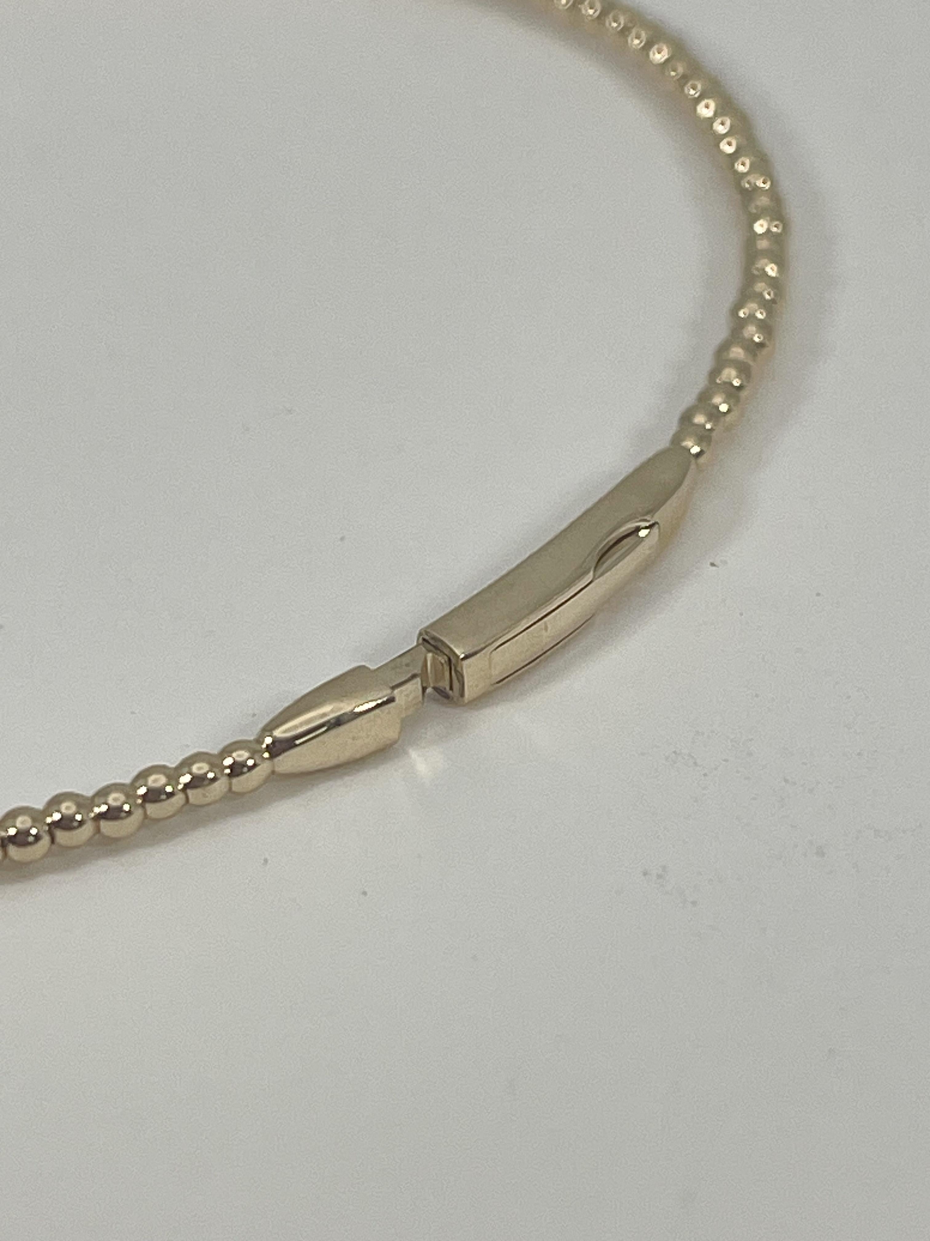14k yellow gold .24 CTW diamond bangle. This bangle has a beaded design around the bangle with round diamonds in the center, this bracelet will fit a wrist up to 6 inches, the width of the bracelet is 1.7mm around the bracelet, the center of the