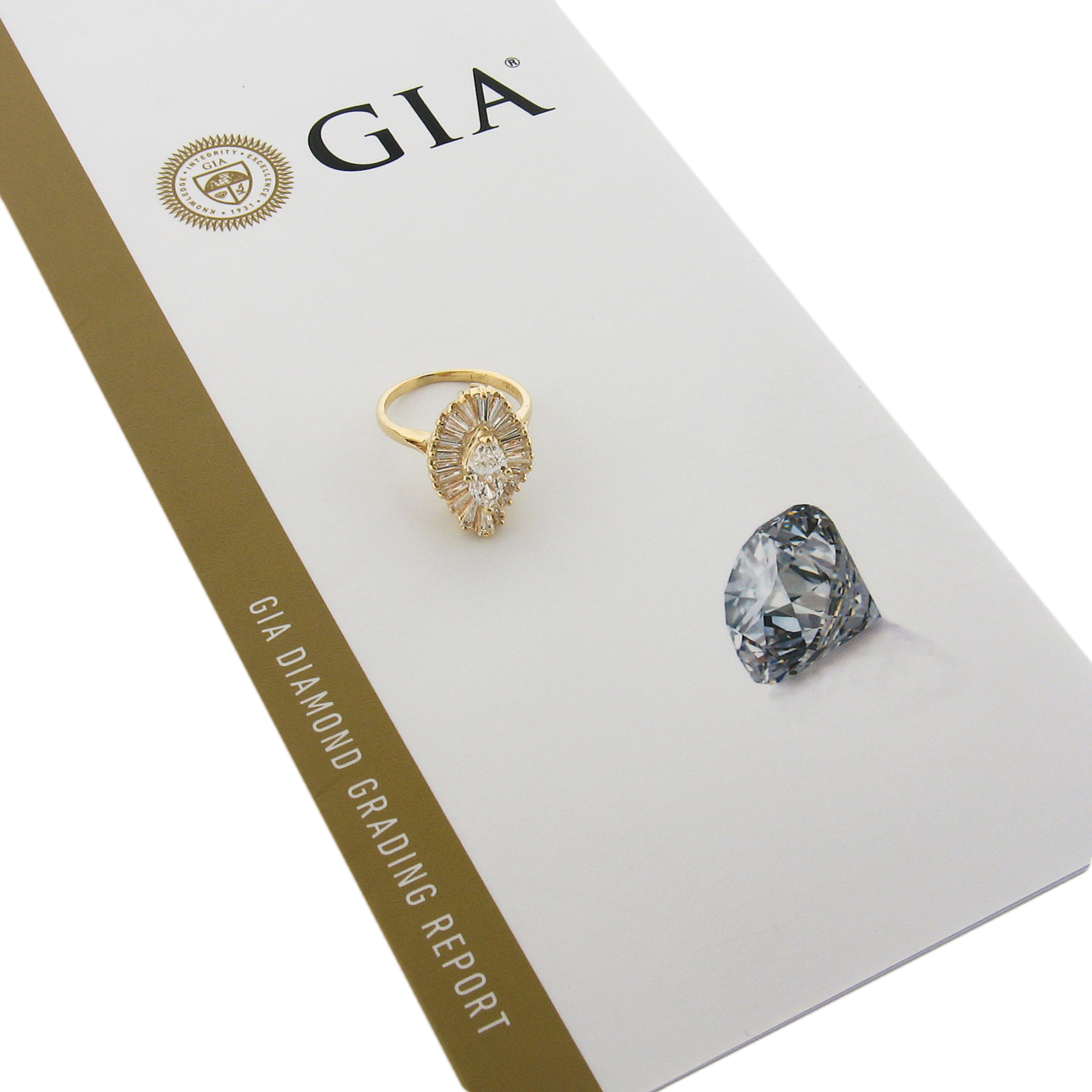 This super fiery and truly jaw dropping diamond ring was crafted in solid 14k yellow gold and features a large wavy ballerina design that carries approximately 2.41 carats of very fine quality diamond throughout. The center of the ring is set with a