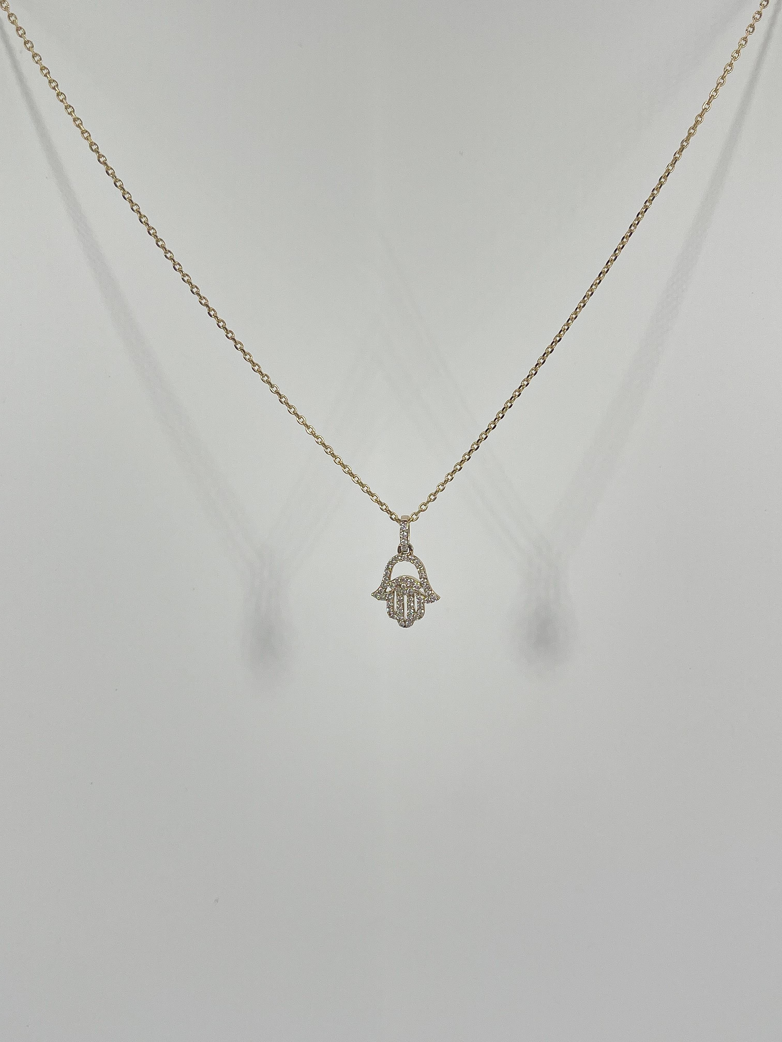 14k yellow gold .25 CTW diamond Hamsa necklace. The pendant comes on an 18 inch cable chain, and has a diamond bail. The pendant measures 9.6 x 9.2 mm and has a total weight of 2.43 grams.