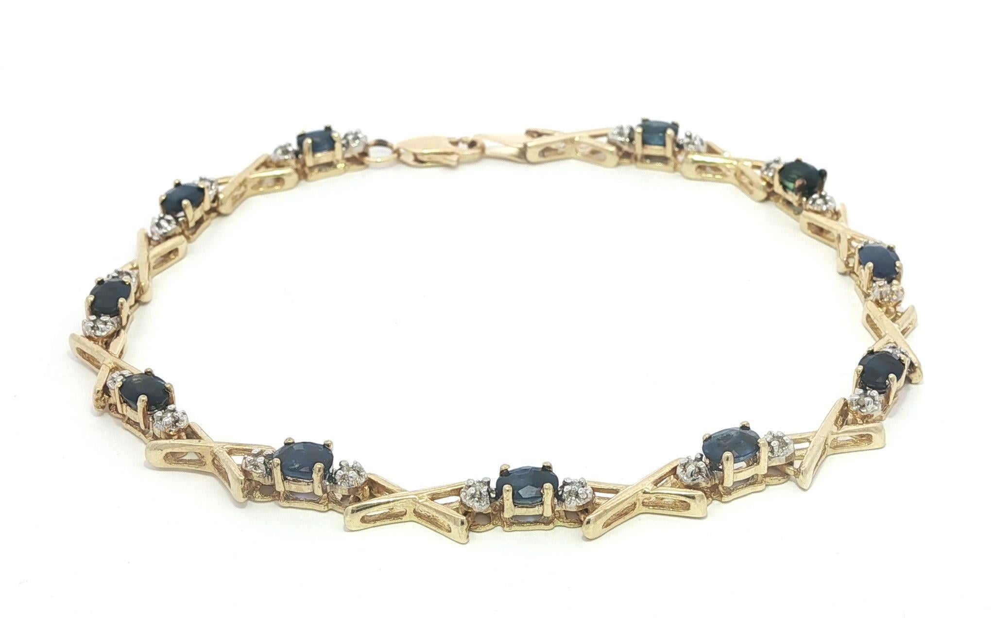 -- Stone(s) --
(11) Natural Genuine Sapphires - Oval Brilliant Cut - Prong Set - Deep Blue Color - 4x3mm - 2.5ctw (approx.)
(22) Natural Genuine Diamonds - Round Brilliant Cut - Prong Set - Commercial Quality

Material: 14K Solid Yellow Gold
Weight: