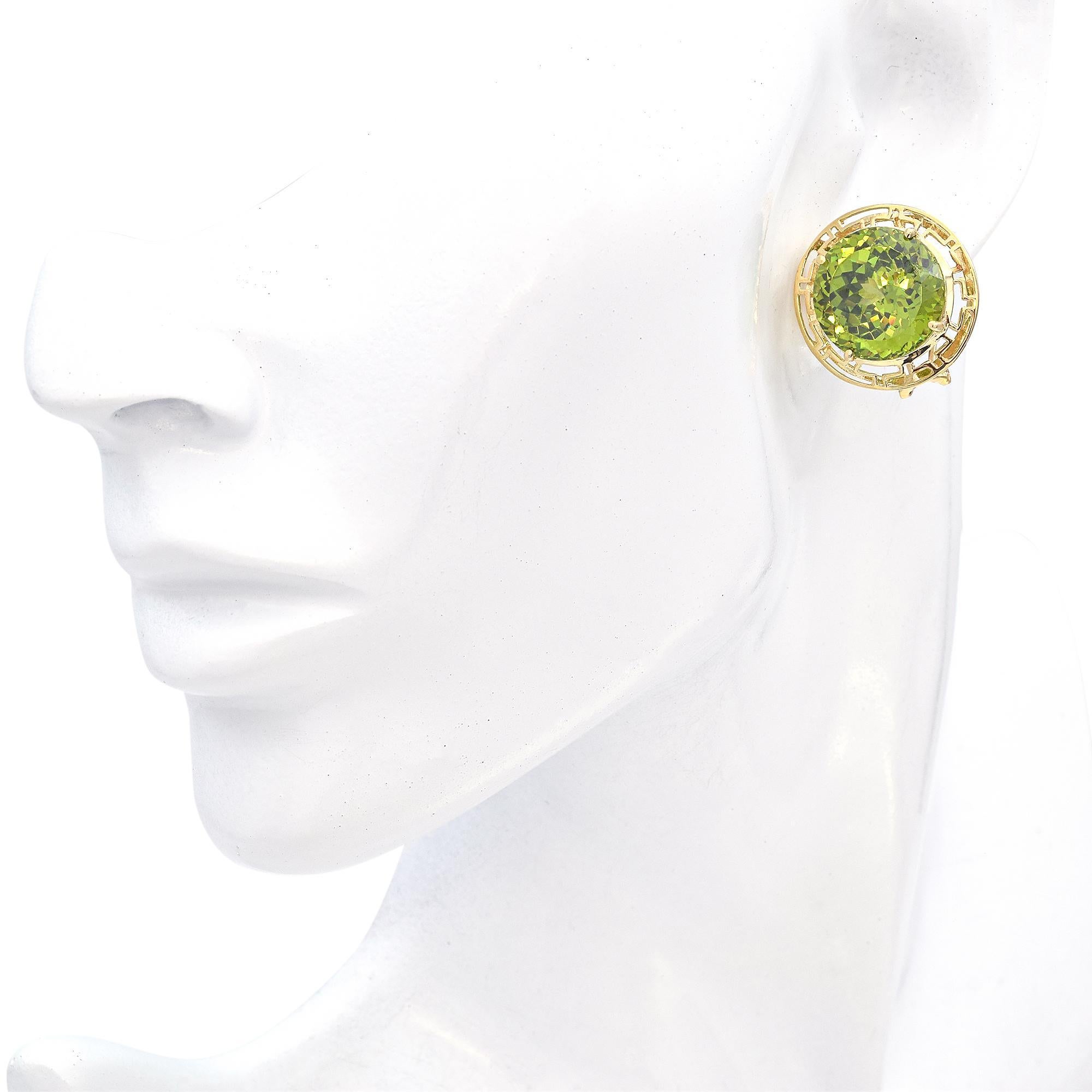 Contemporary elegance captured in these stunning stud earrings. Each piece features a radiant-cut green peridot, totaling 27.24 carats, set in a 14k yellow gold frame. The intricate openwork design enhances the vibrant hue of the stones.

Weight: