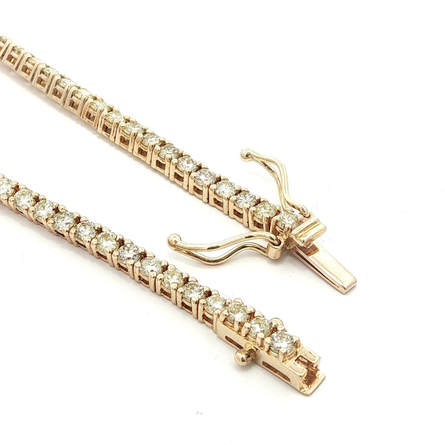 –Stone(s)–
(73) Natural Genuine Diamonds - Round Brilliant Cut - Prong Set - Fiery & Brilliant - Faint Yellow Color -SI1-I1 Clarity - 2.92ctw (approx.)

Material: Solid 14k Yellow Gold
Weight: 7.08 Grams
Type: Tennis Line Link Tennis
Length:
