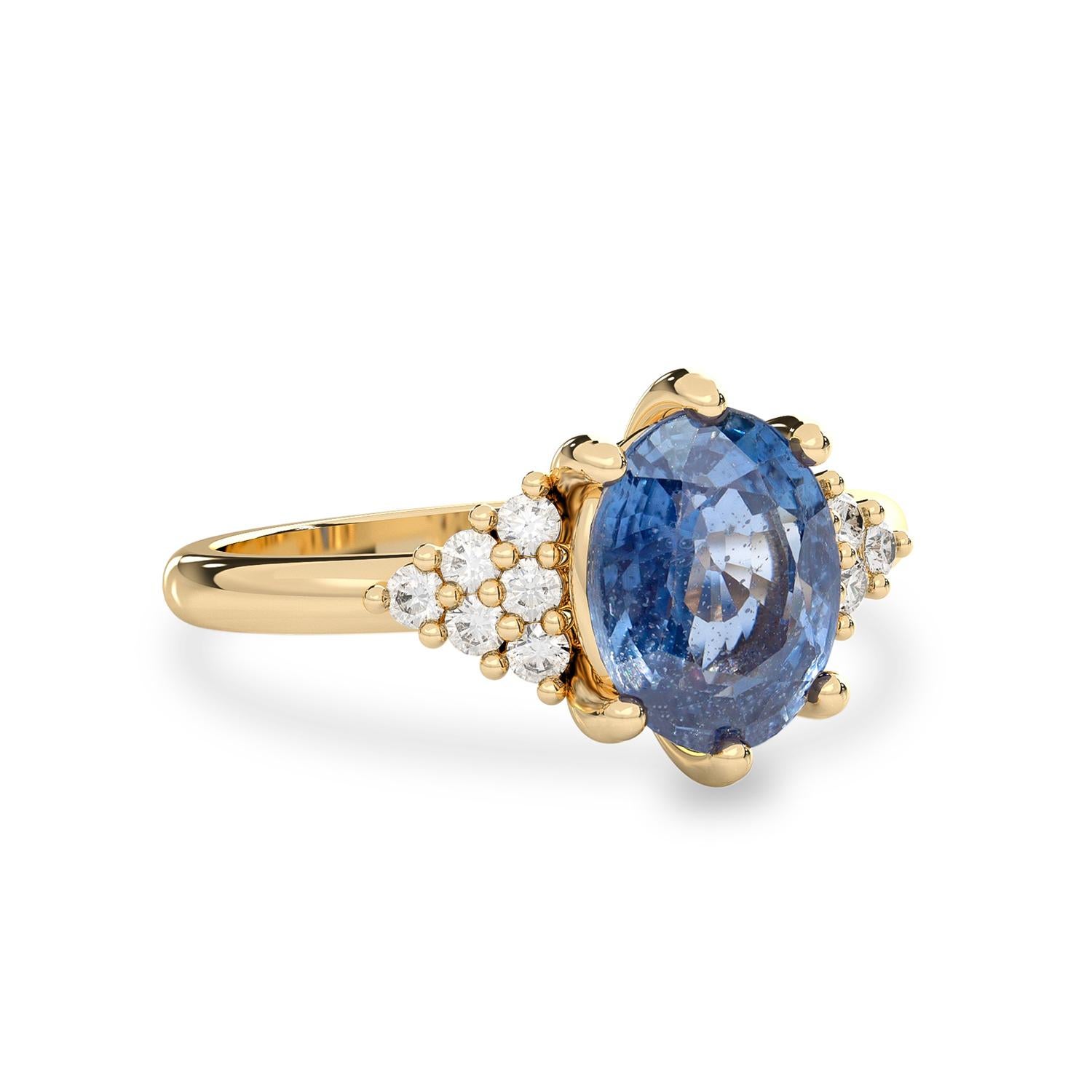 Classic simplicity defines this elegant Emma Engagement Ring, which features a 14k yellow gold straight comfort fit ring shank under the triangle form diamond accent on each side of the natural blue sapphire. The center stone features an