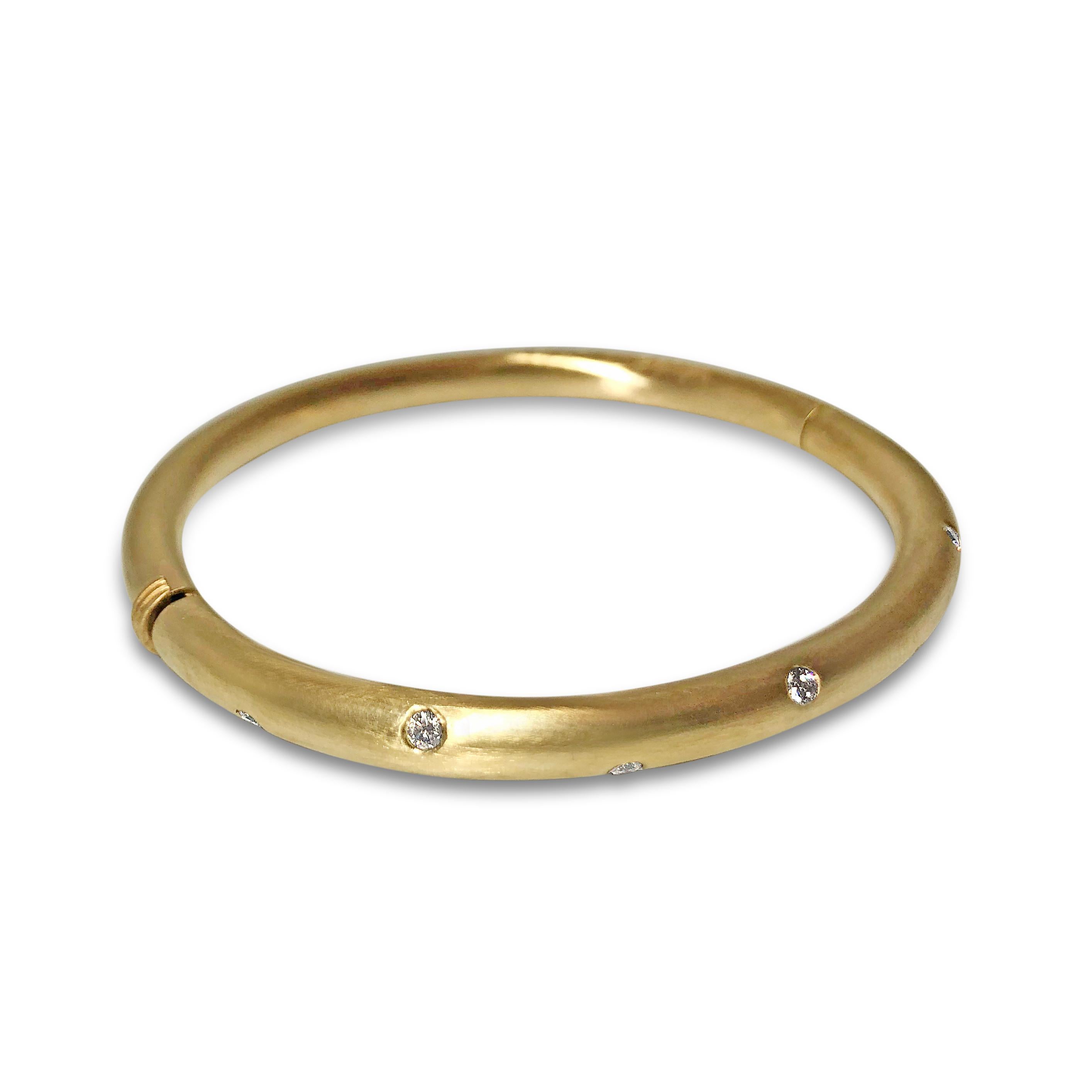 Our ‘T-7’ 14K brushed matte yellow gold bangle dotted with diamonds is a show-stopper. The 3/16 inch bracelet features seven round 2.3mm white diamonds, totaling 0.37ct. The bangle securely closes with a snap & hinge.

Specifications:
- Stone(s):