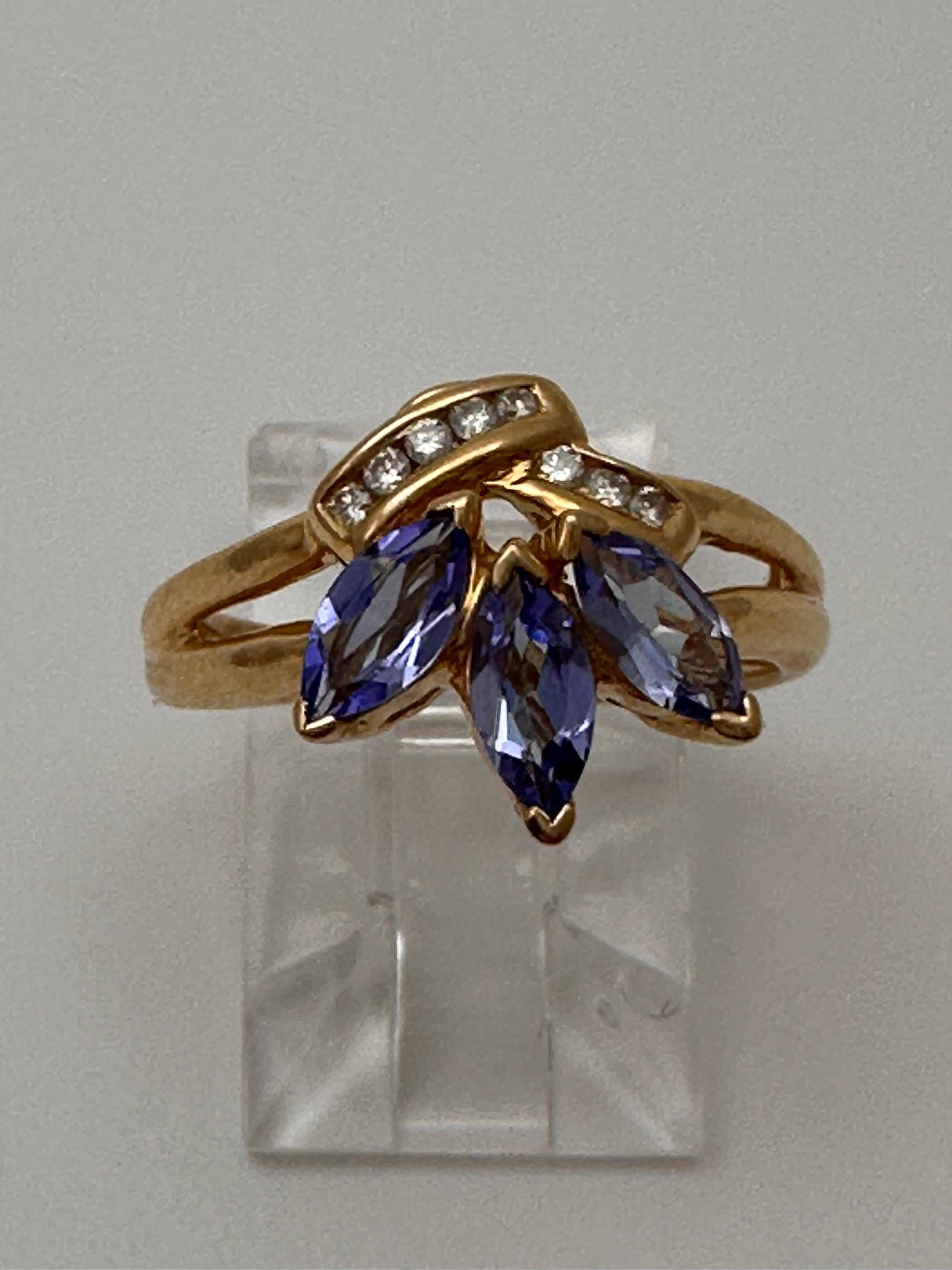 14k Yellow Gold approx. 6mm x 8mm Pear Tanzanite
8 Diamonds 
Ring Size 5 3/4

Tanzanite 

Tanzanite changes colors when it is viewed from different directions. This shifting of colors has been said to facilitate raising consciousness. It aids in