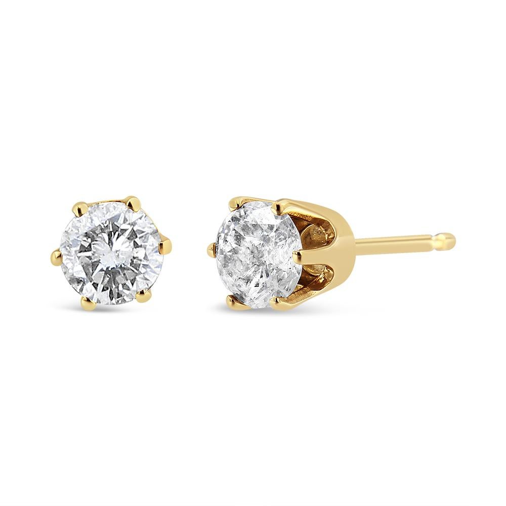 These small solitaire stud earrings are delicately crafted in lustrous 14k yellow gold. 3/4ct natural round cut diamonds are held by a 6 prong setting that allows the light to flow through the diamond and make it shine. A push back secure mechanism