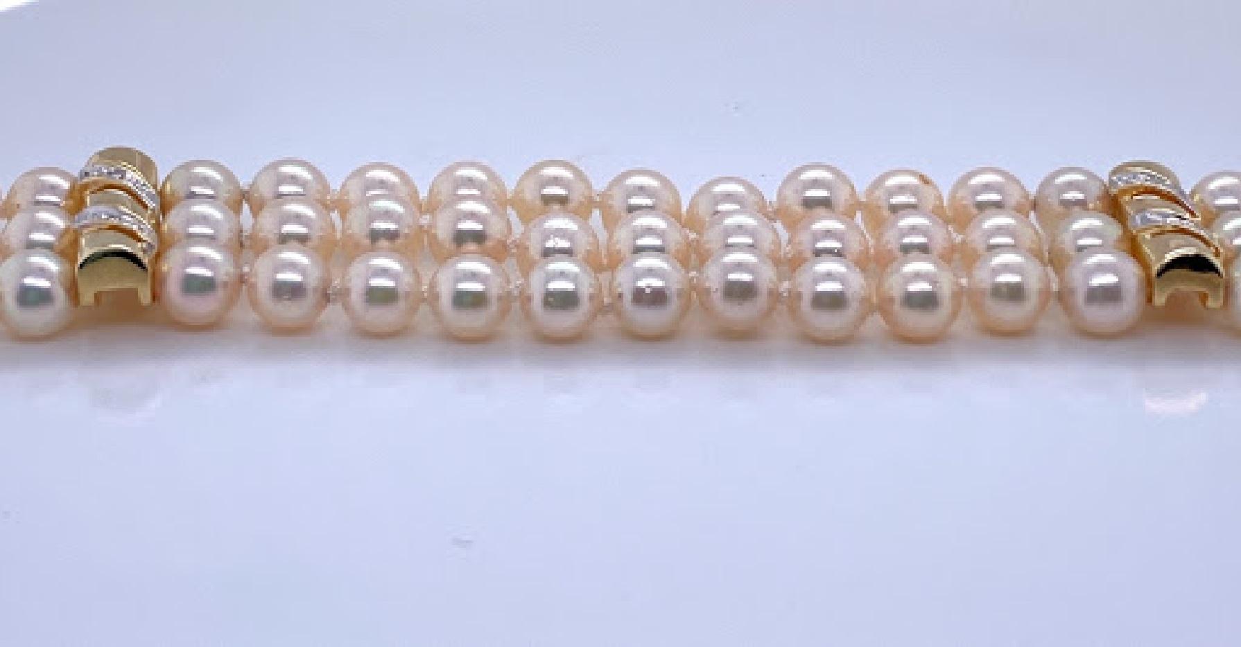 14 karat yellow gold (stamped 585) 3 strand pearl bracelets with two spacers and a bar clasp. Each spacer as well as the clasp are set with two round brilliant diamonds approximately 0.06 I/J color, and SI. There are 90 pearls total that are 5 - 5.5