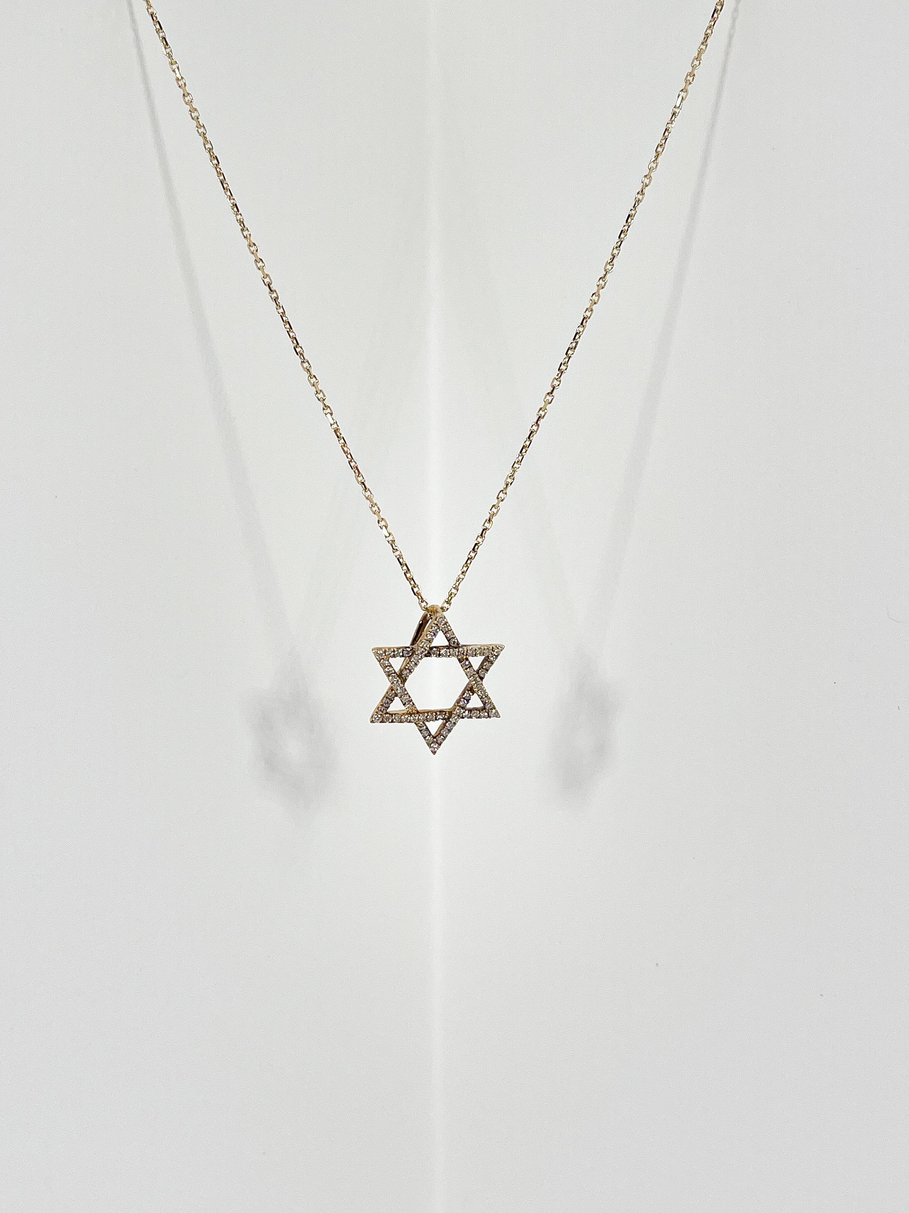 14k yellow gold .30 CTW diamond Star of David pendant necklace. The diamonds in the pendant are round, the pendant measures 17.3mm x 15mm, has a lobster clasp to open and close, pendant comes on a 16-inch diamond cut cable chain, and the necklace