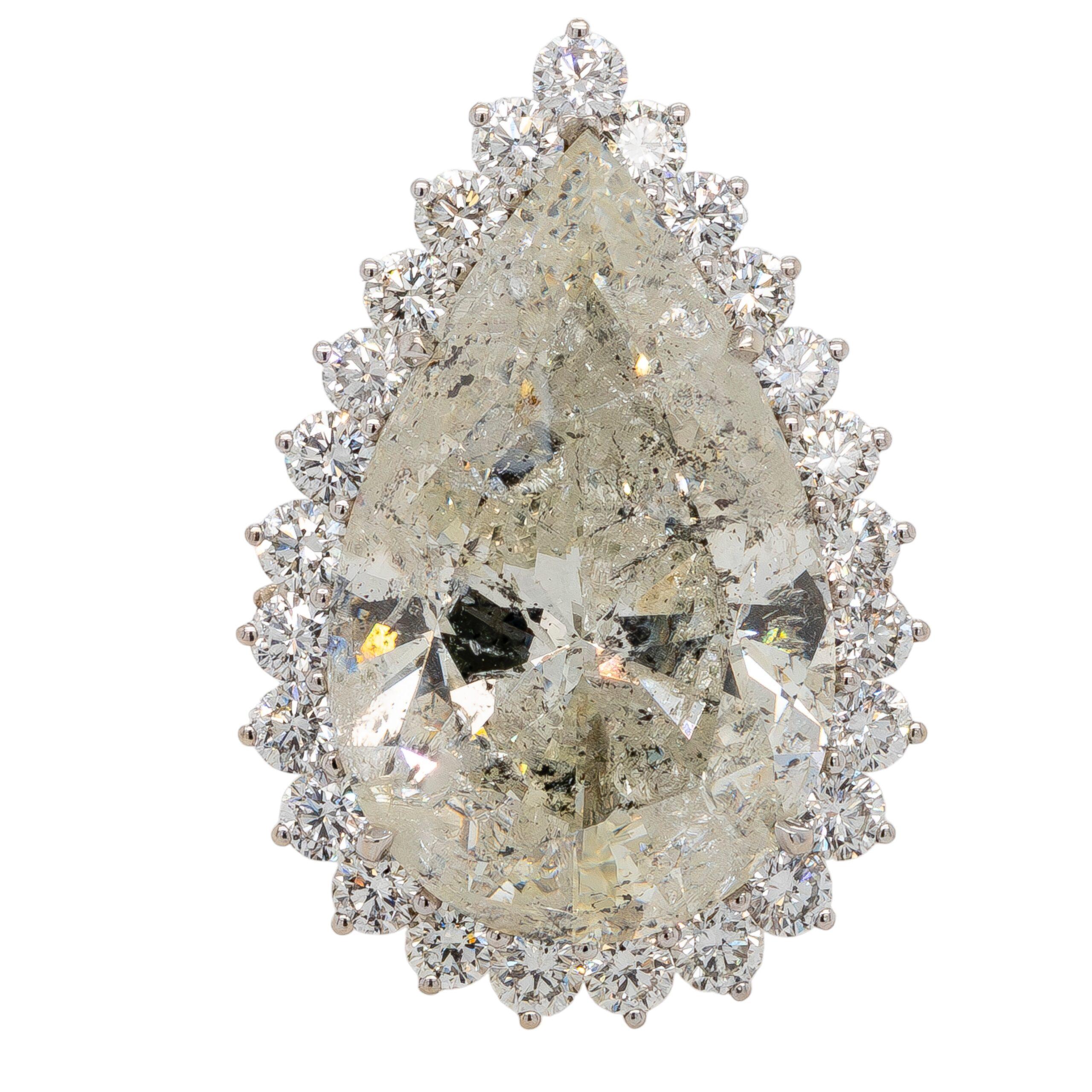 This breathtaking statement ring combines opulence with artistry, featuring a remarkable 27.54ct I/I2 natural diamond as its centerpiece. Accentuated by 30 expertly set round brilliant diamonds totaling 3.01ctw, this ring exudes glamour and