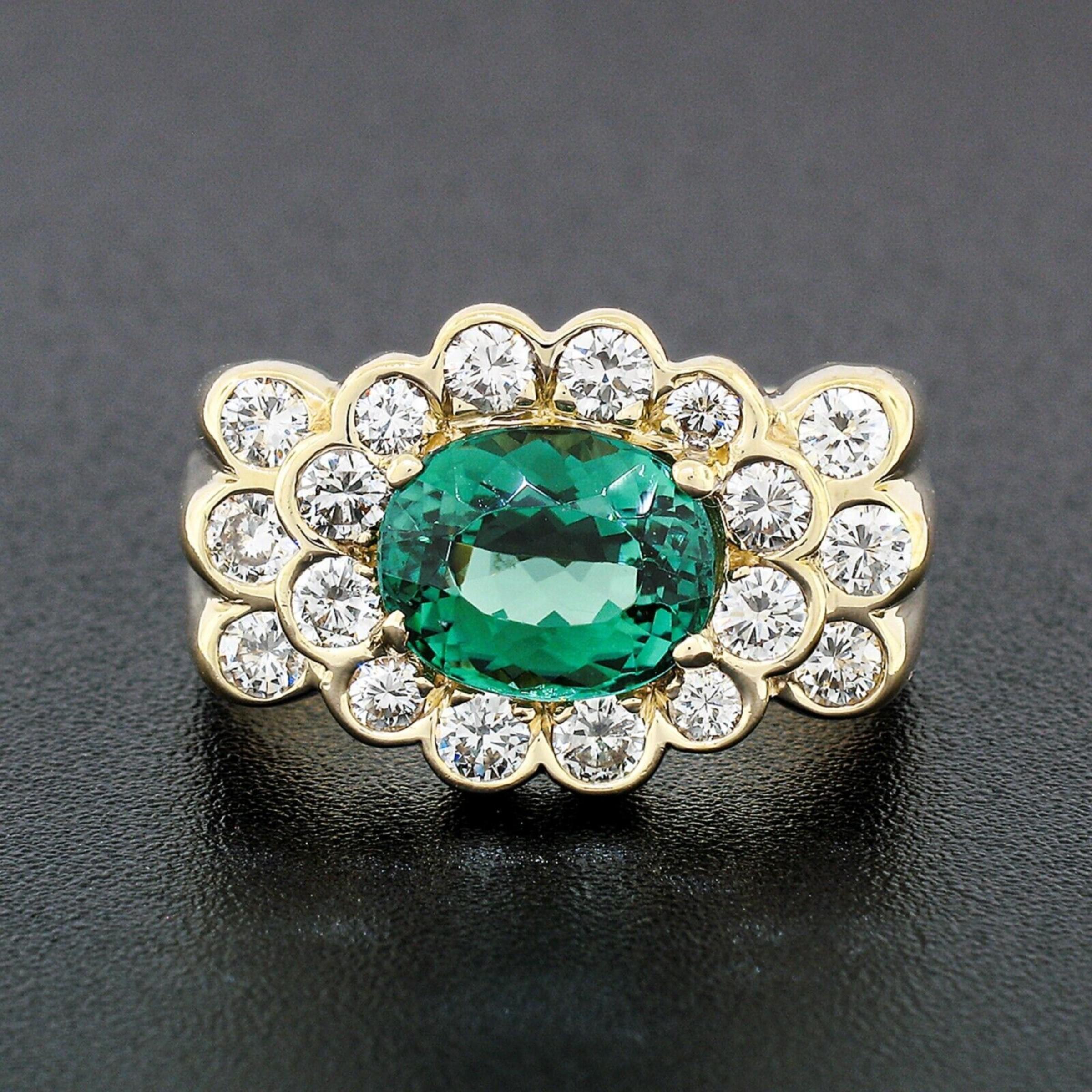 This breathtaking cocktail ring was crafted from solid 14k yellow gold and features a very fine tourmaline solitaire surrounded by stunning diamonds in which completely cover the top of the ring. The oval tourmaline lays sideways, neatly set at the