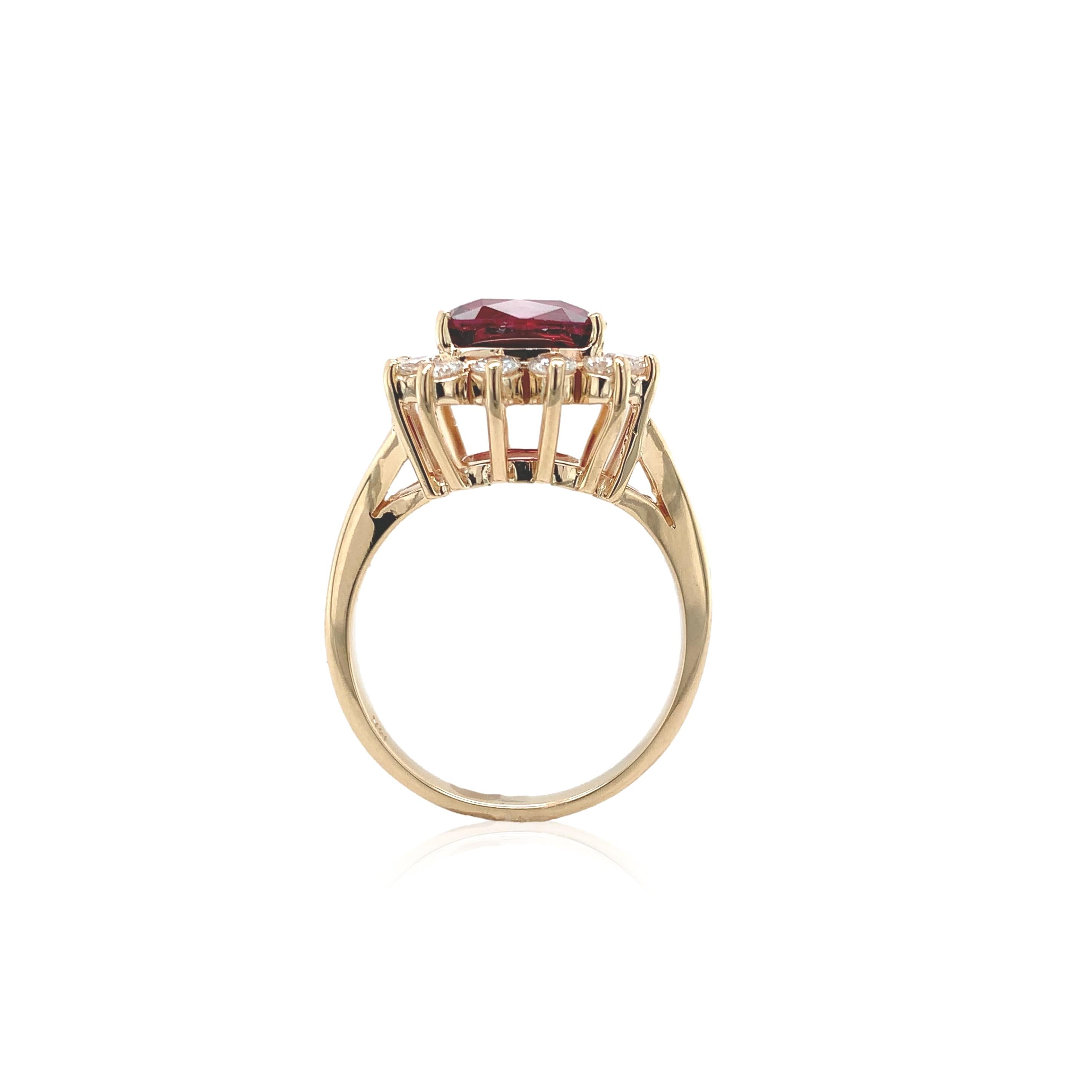 14K rosy yellow gold ring set with a cushion cut garnet weighing 3.75 carats. The very pretty Tanzanian purplish-pink colored garnet has fuchsia fire. It measures about 8.6mm square. Restored with 1 new prong and the other 3  prongs have been
