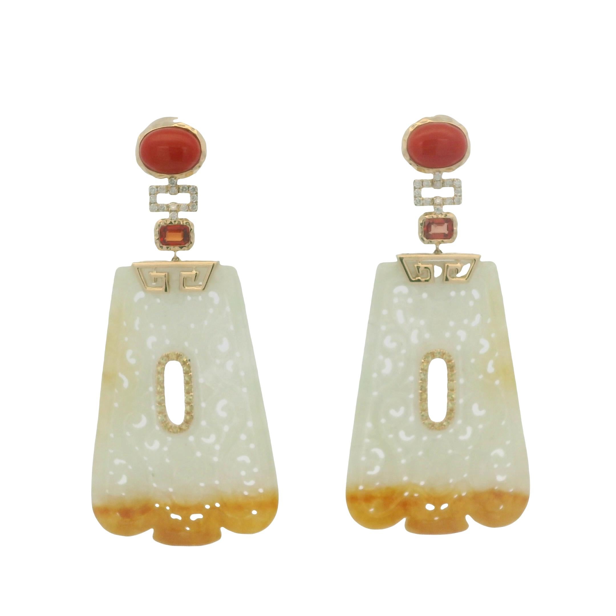 These earrings are a masterful blend of artistry, color, and craftsmanship. Handcrafted in 14 karat yellow gold, each piece features an impressive 38.26 carats of carved jade, delicately shaped into a graceful fan-like silhouette. The jade displays
