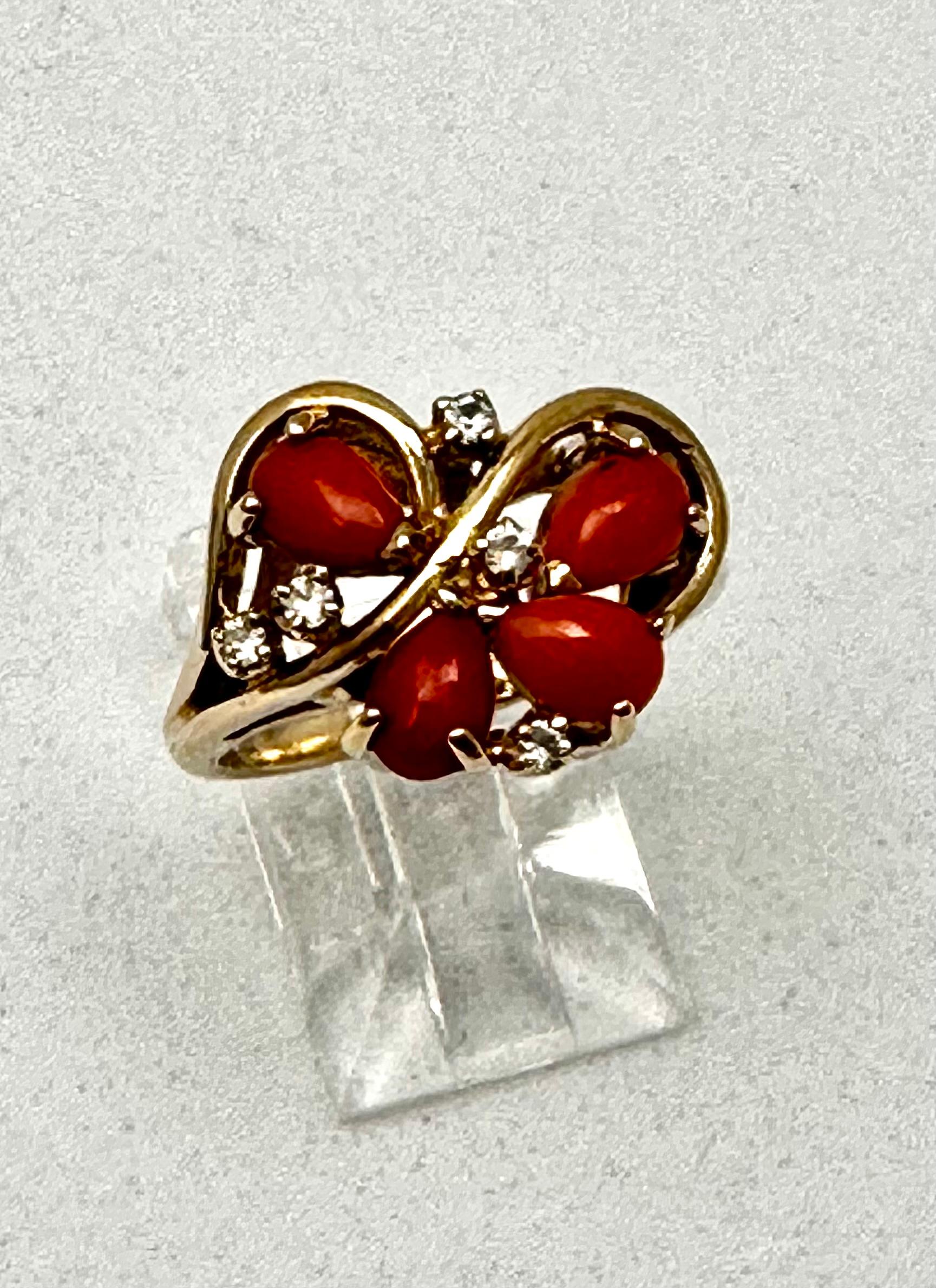 14k Yellow Gold  4 Pear Shaped Coral and Diamonds  Ring Size 6 1/4
Stones are a little more on the salmon color then what shows in photos...pretty ring 

Coral represents happiness and joy and gives the person the ability to appreciate life. Coral