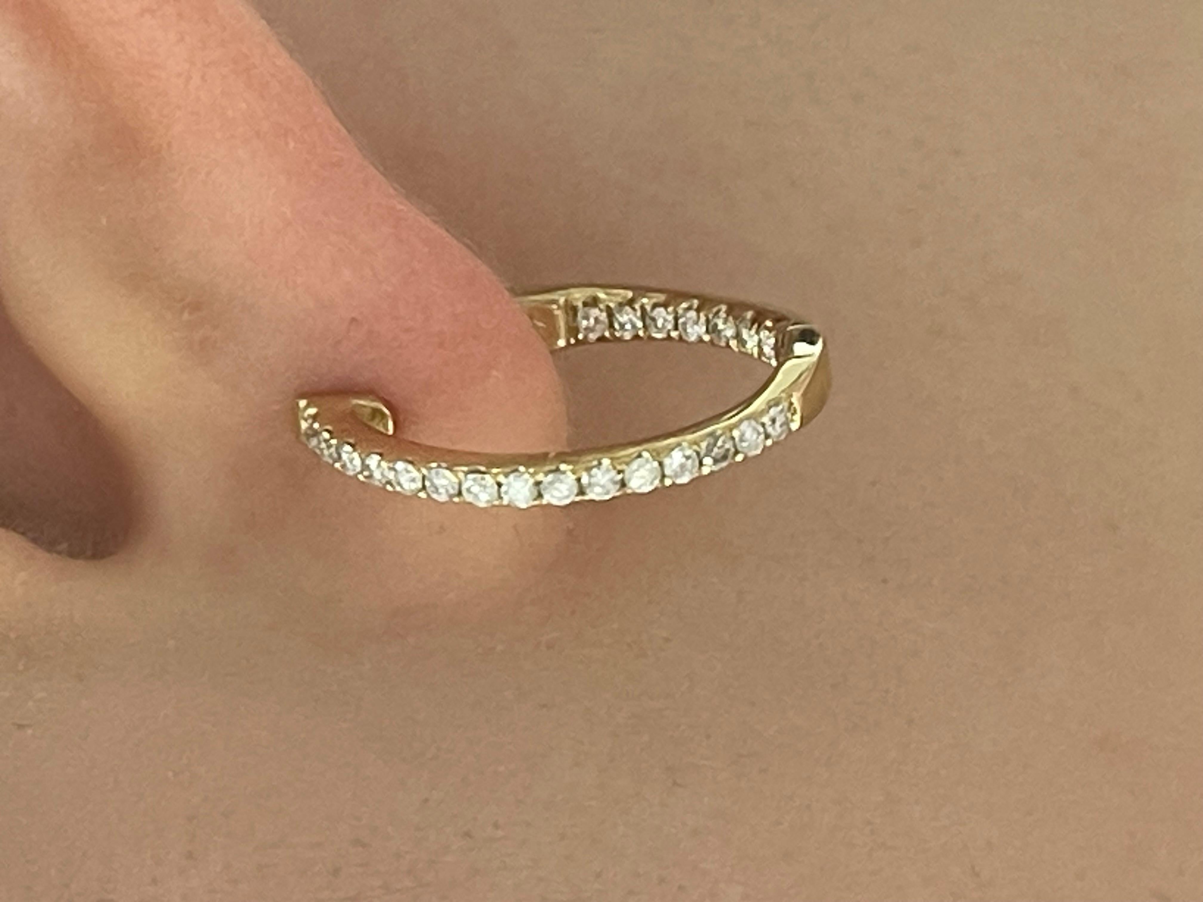 14k yellow gold .45 CTW diamond in & out hoops. The diamonds in these hoops are all round, they measure to be 20mm x 18mm, has a safety clasp to open and close, and has a total weight of 3.7 grams