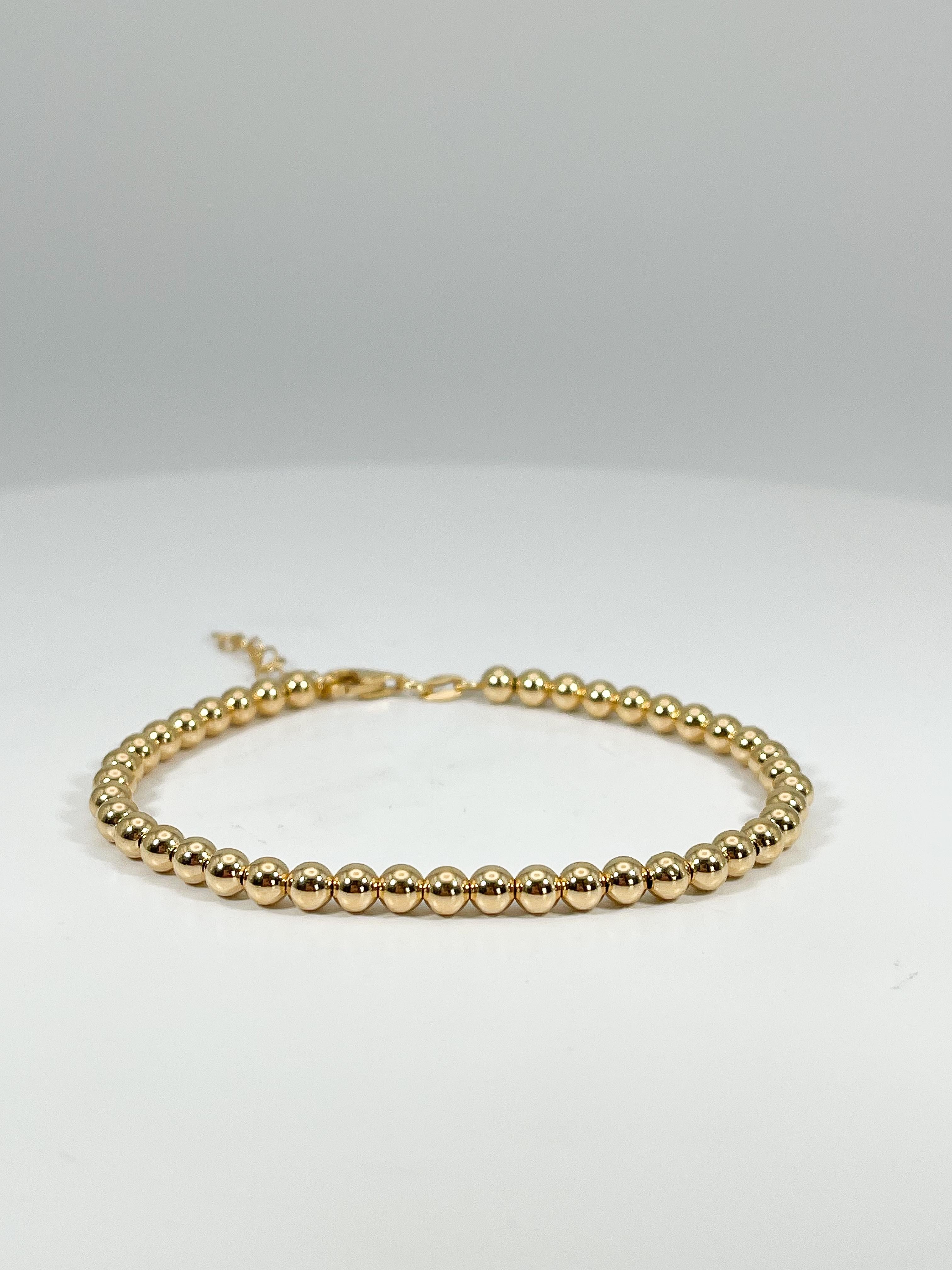 14k yellow gold 4 mm beaded bracelet. This bracelet has a lobster clasp for wearing, the length of the bracelet is 8 inches long, but is adjustable, the total weight is 3.1 grams.